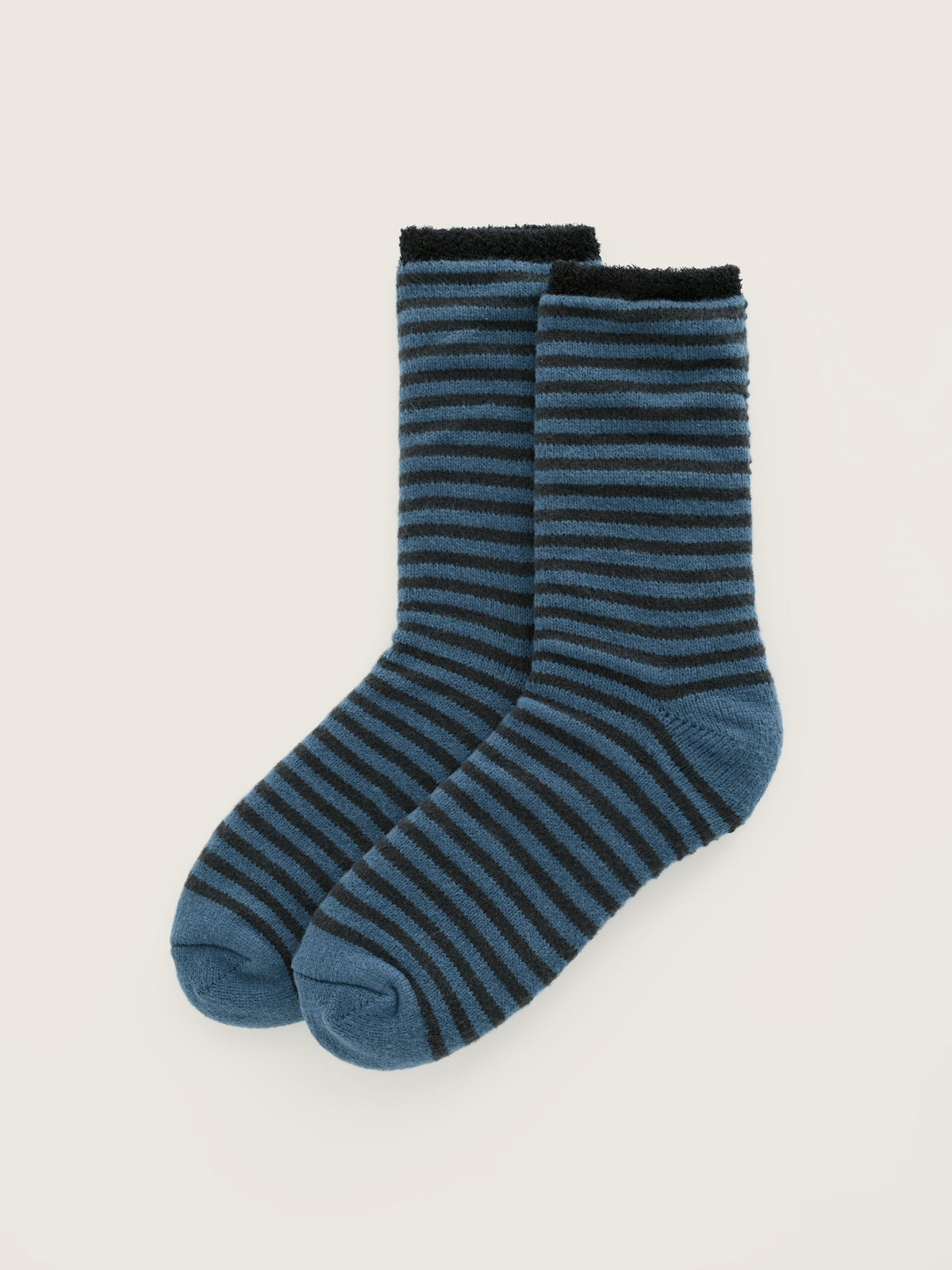 A pair of men's Seasalt Cornwall blue striped fluffy cosy socks isolated on a neutral background.