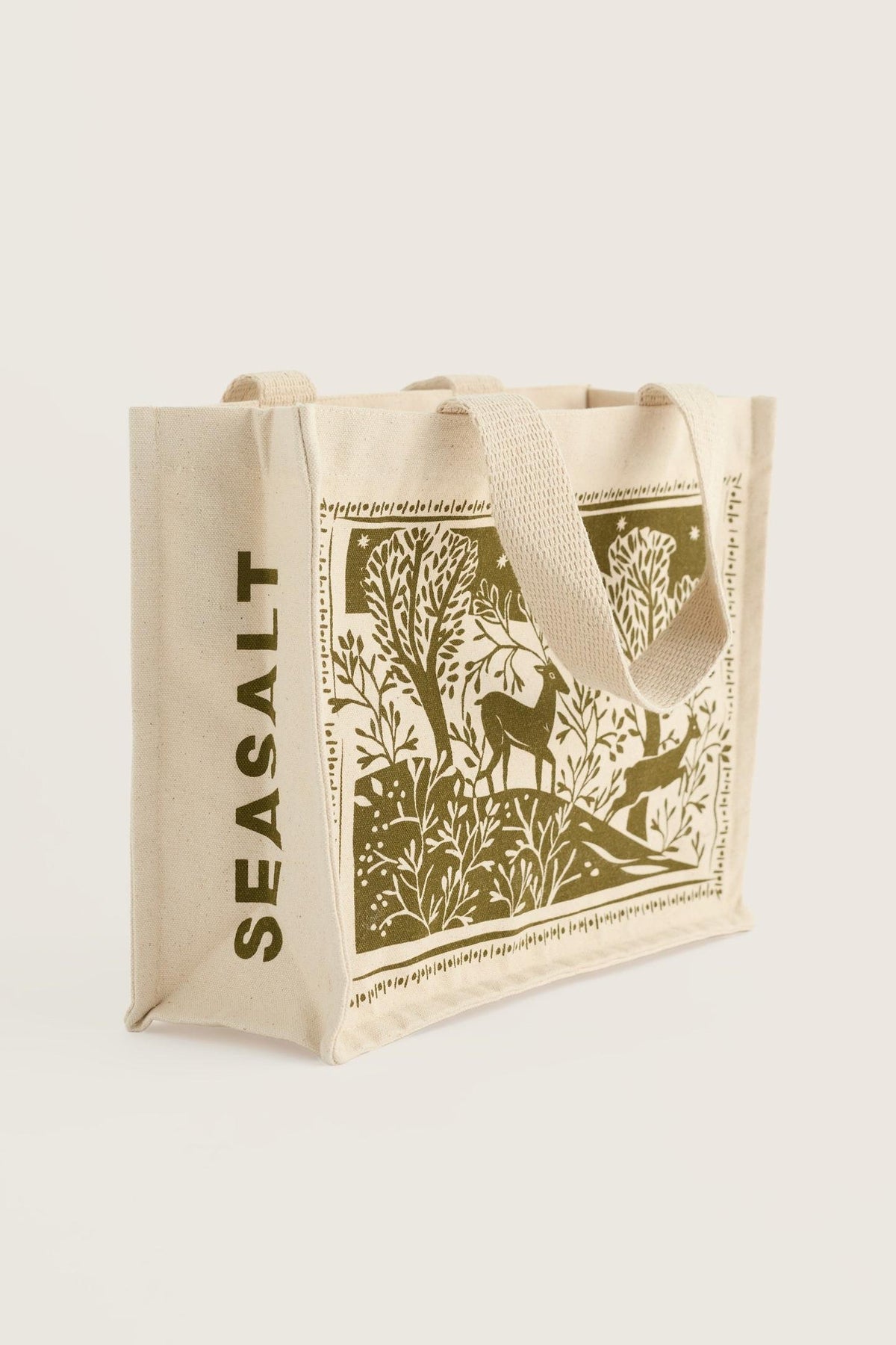 Seasalt Cornwall organic cotton canvas reusable shopping bag with green winter forest and deer print.