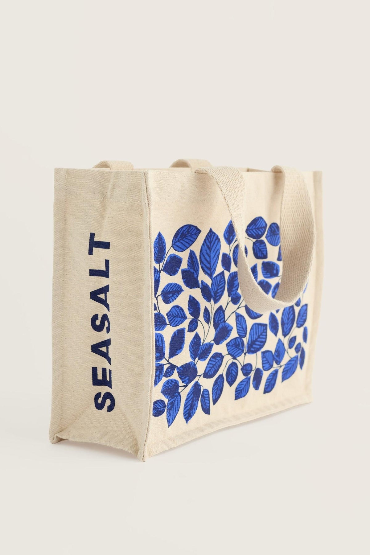 A Seasalt Cornwall organic cotton canvas shopping bag with a blue leaf pattern against a plain light background.