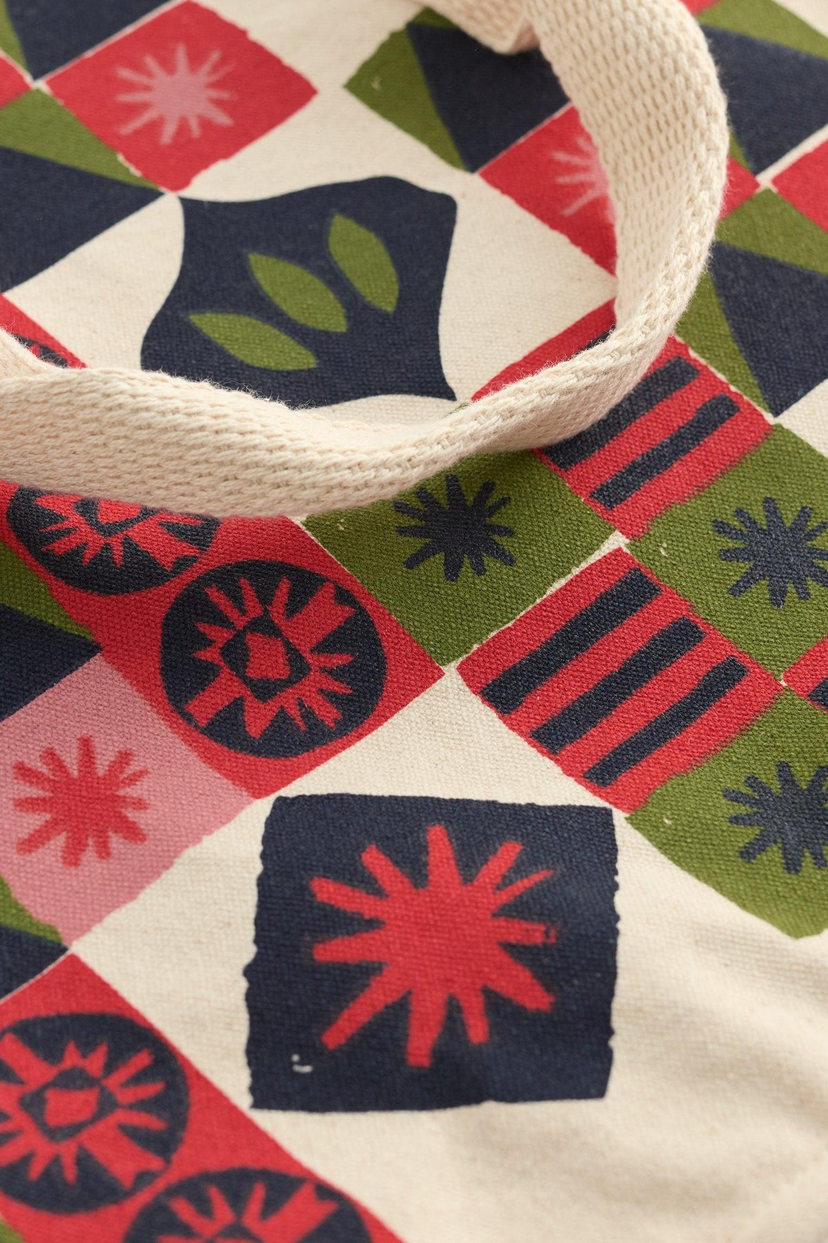 Seasalt Cornwall canvas shopping bag with a colorful geometric and star-patterned print.