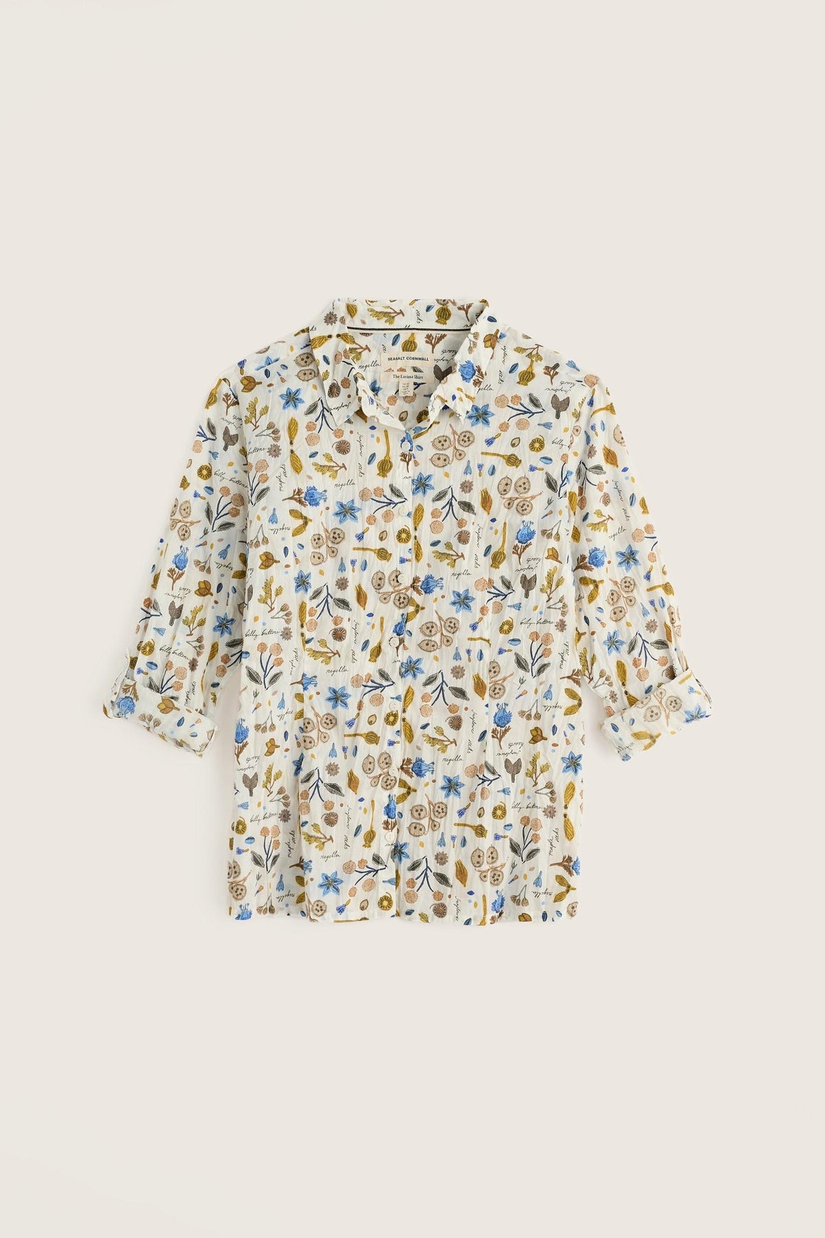 A Seasalt Cornwall women's shirt in white cotton featuring a delicate blue and gold botanical print.