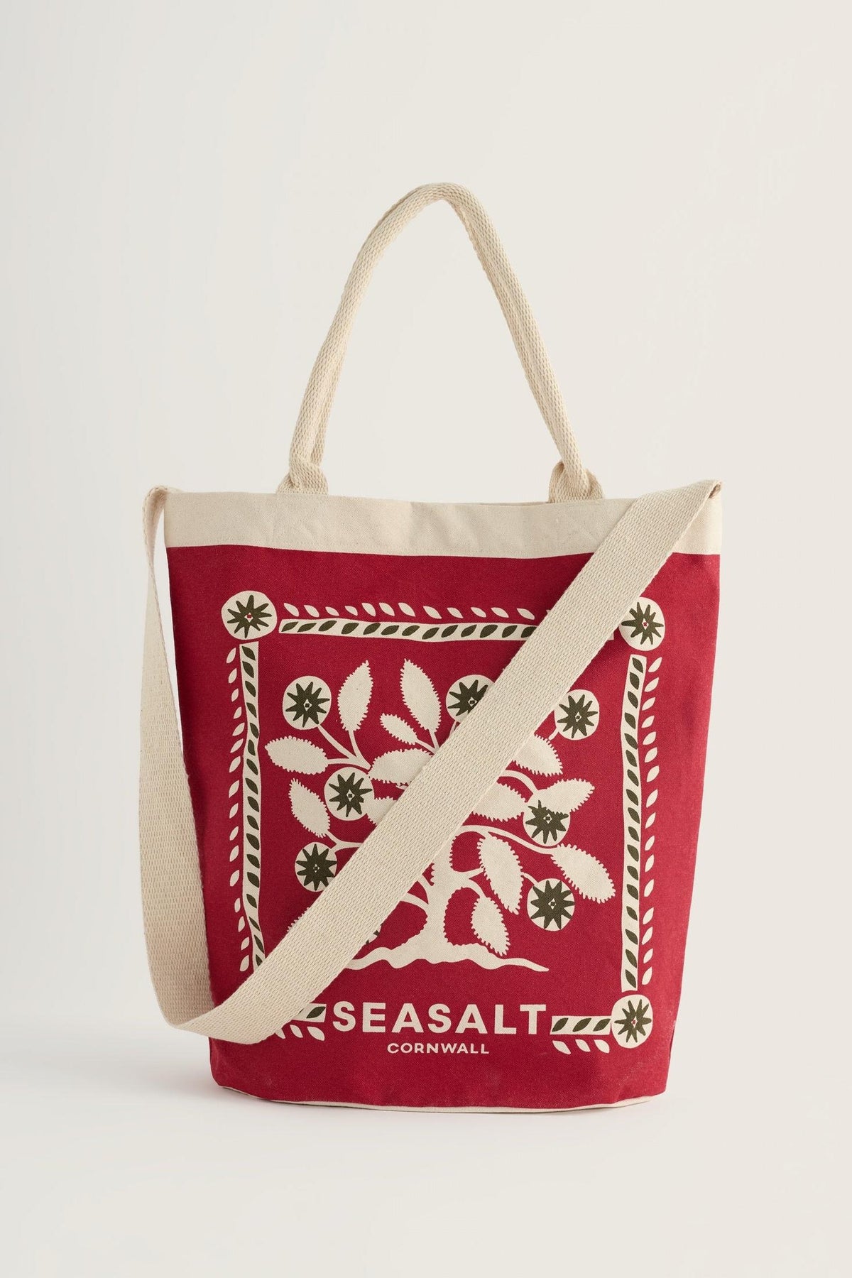 Seasalt Cornwall red canvas shopping tote bag with festive tree print against a plain white background.