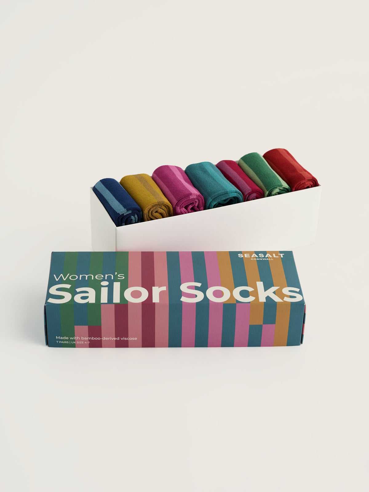 A Seasalt Cornwall gift box containing seven pairs of colourful striped women's bamboo socks.