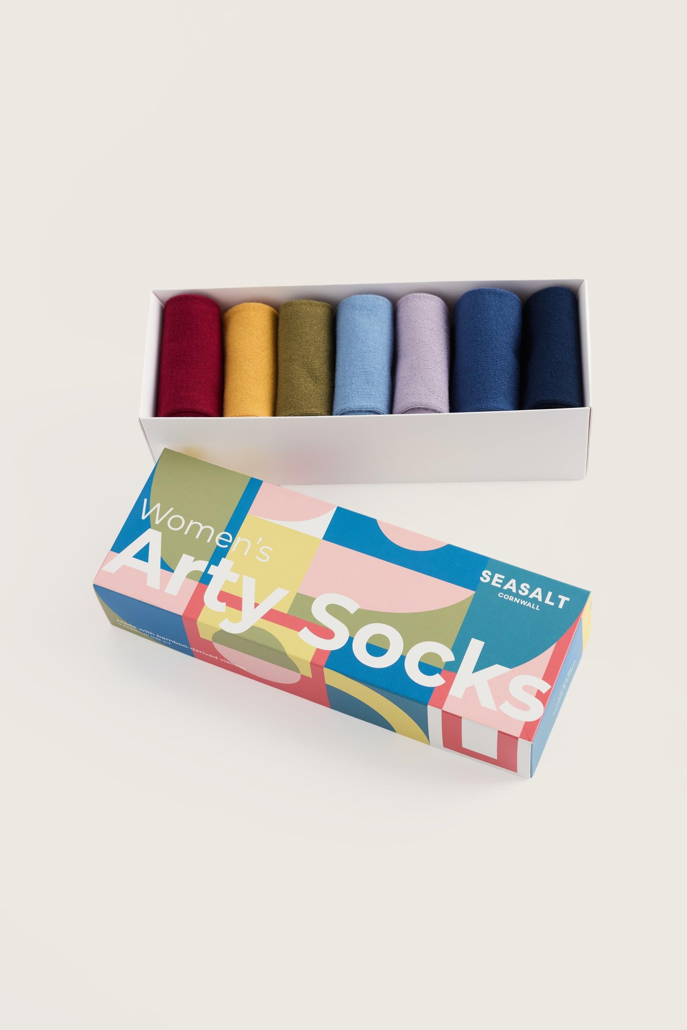 Seasalt Cornwall giftbox containing seven pairs of colourful women's socks in a clean studio setting.