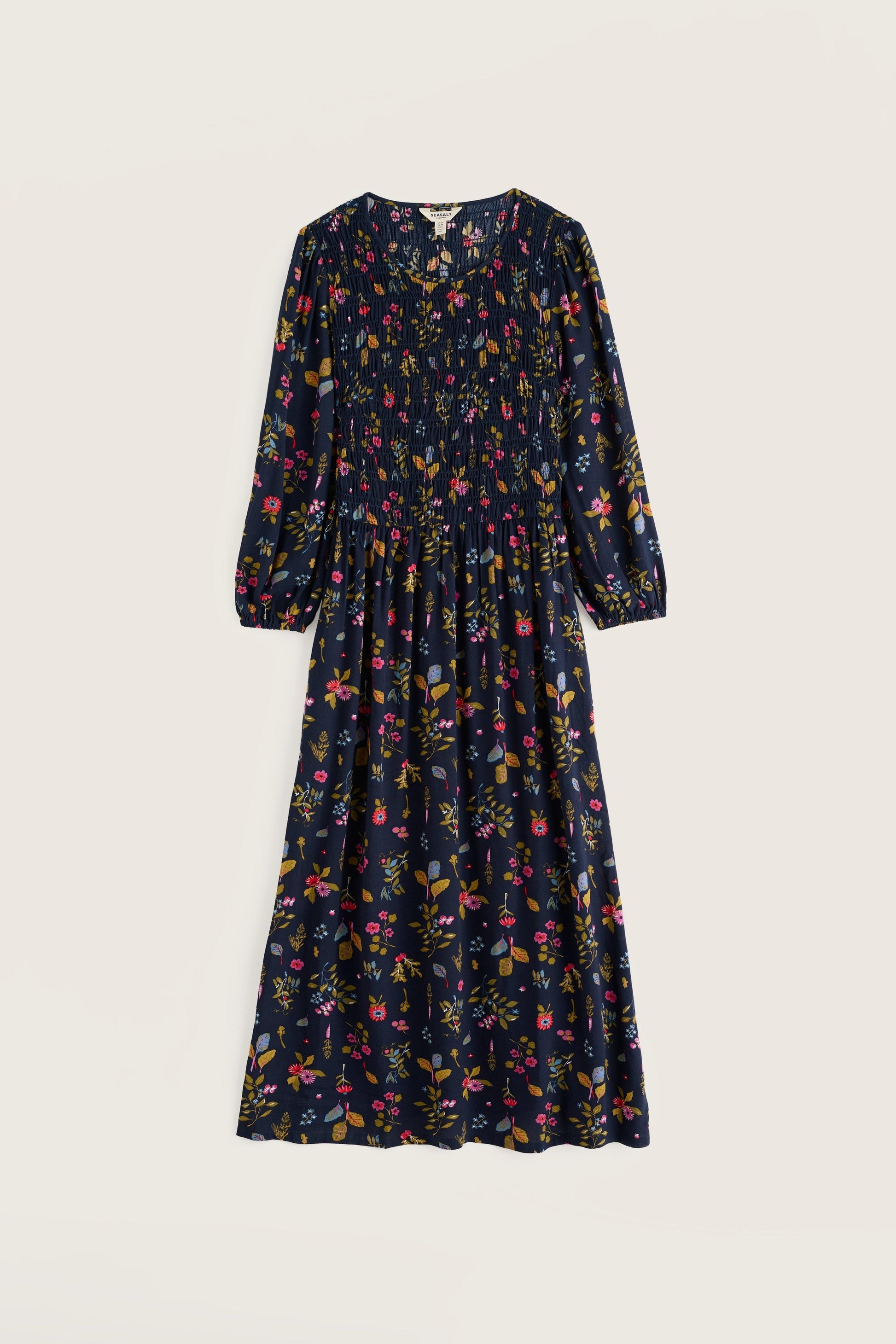 A long-sleeved midi dress with a dark navy blue base and an all-over multicolor floral print, shown flat against a light beige background.
