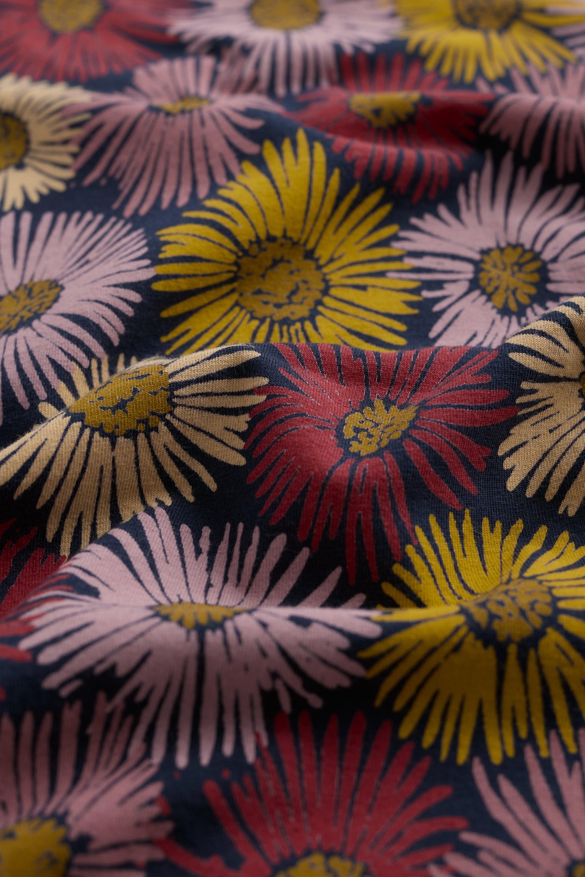 Close-up of colorful floral fabric with a dark background