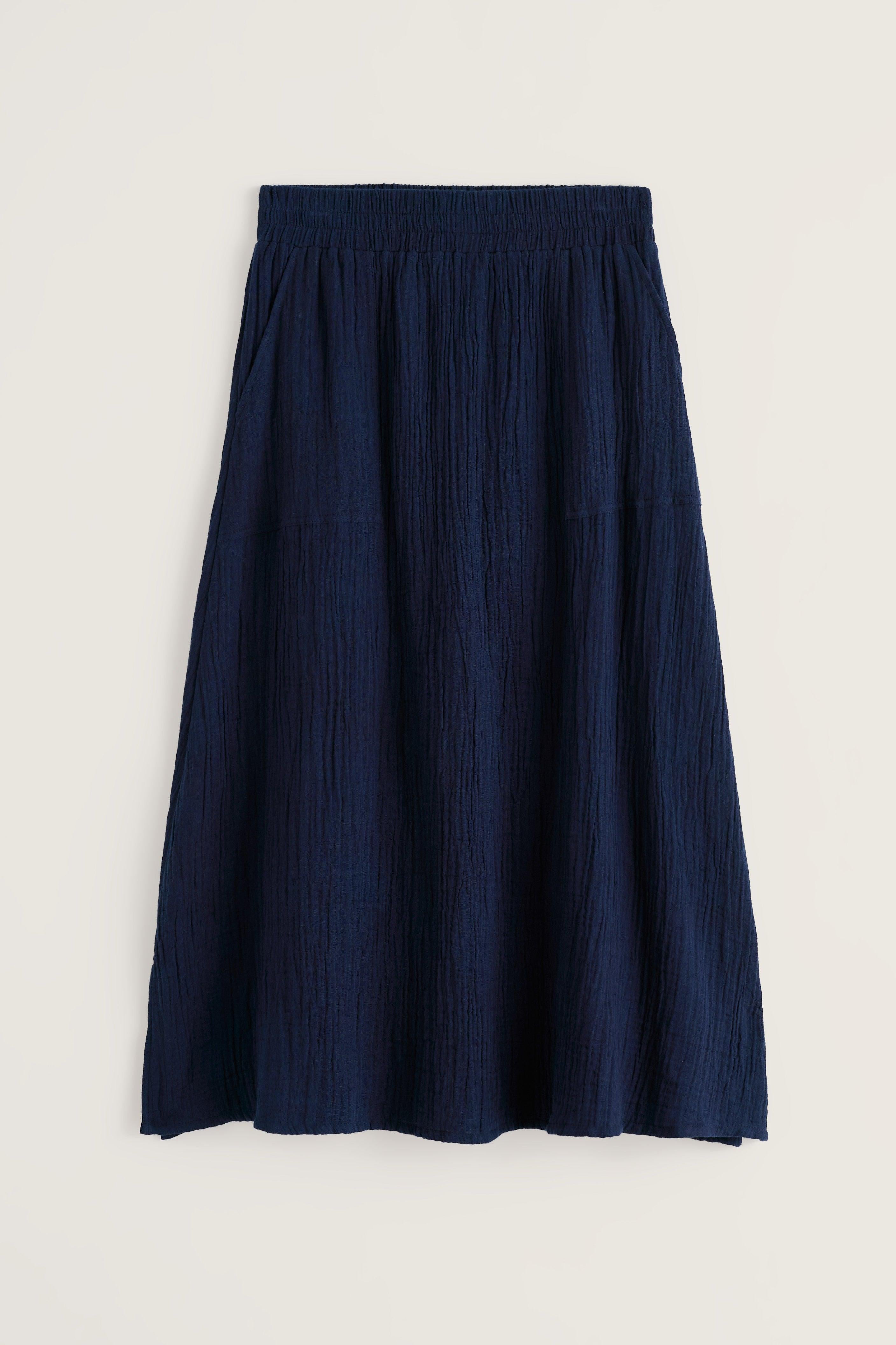 Navy midi skirt flat laid on white background