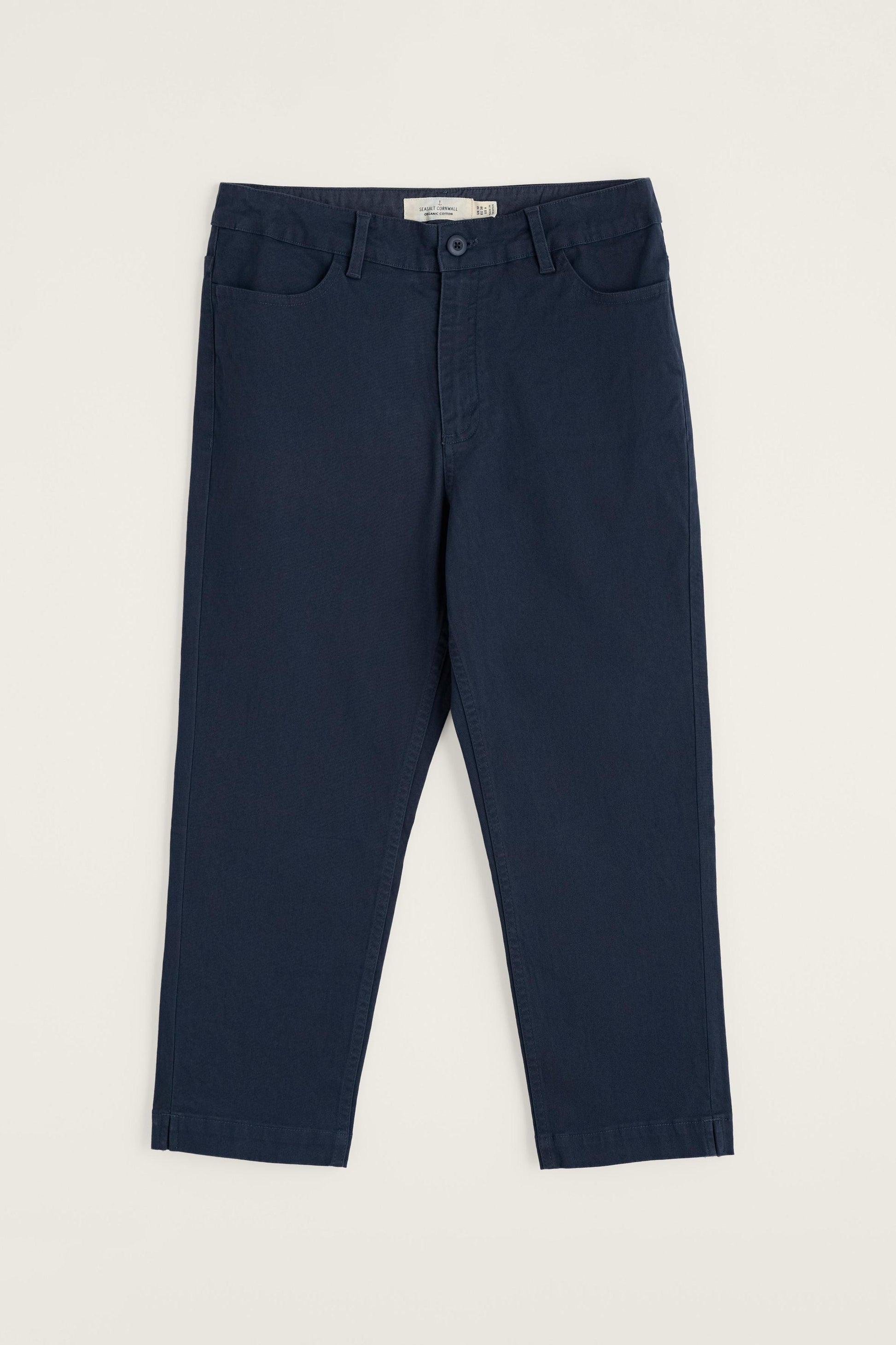 Navy blue organic cotton pants on a light beige background