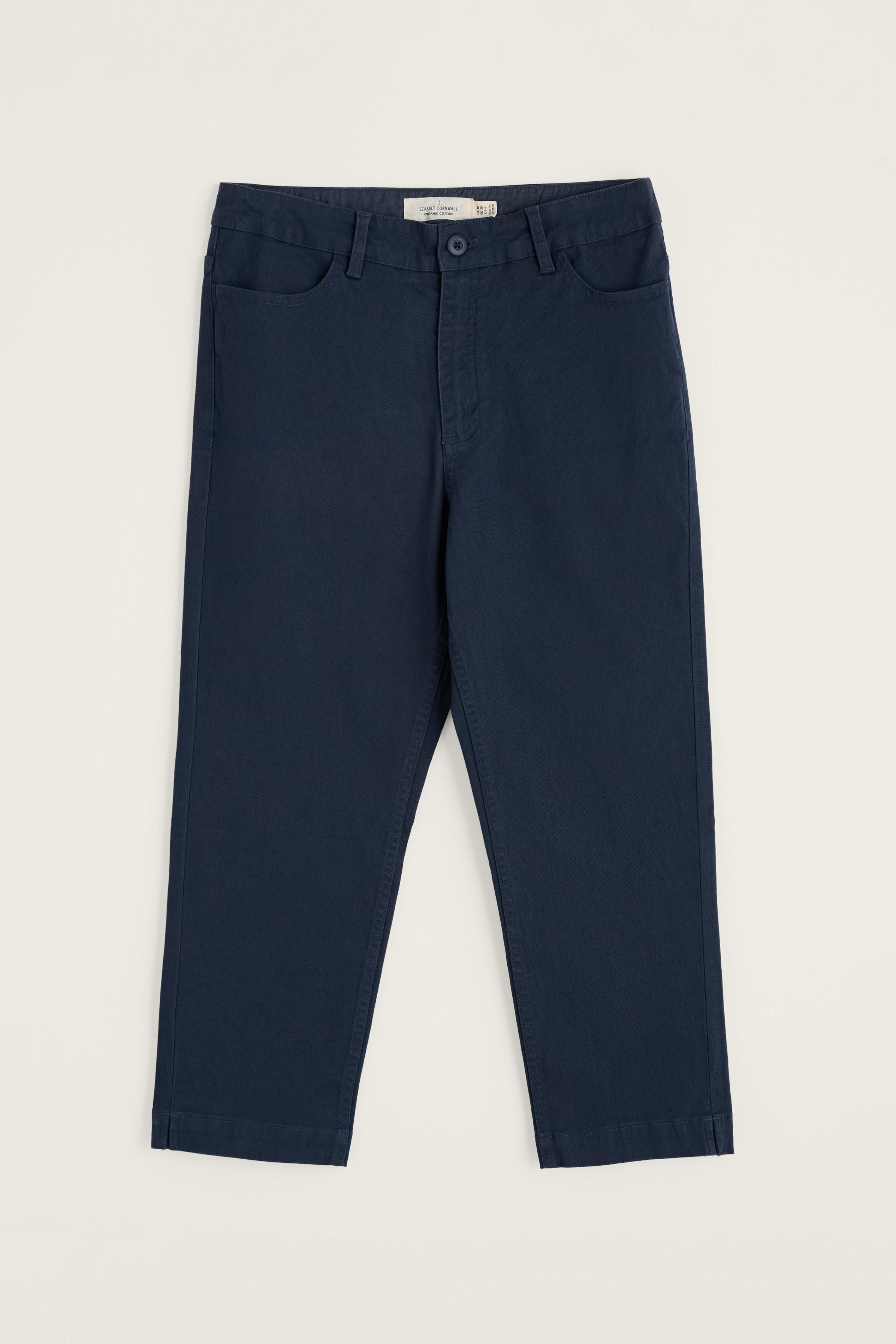 Navy blue organic cotton pants on a light beige background