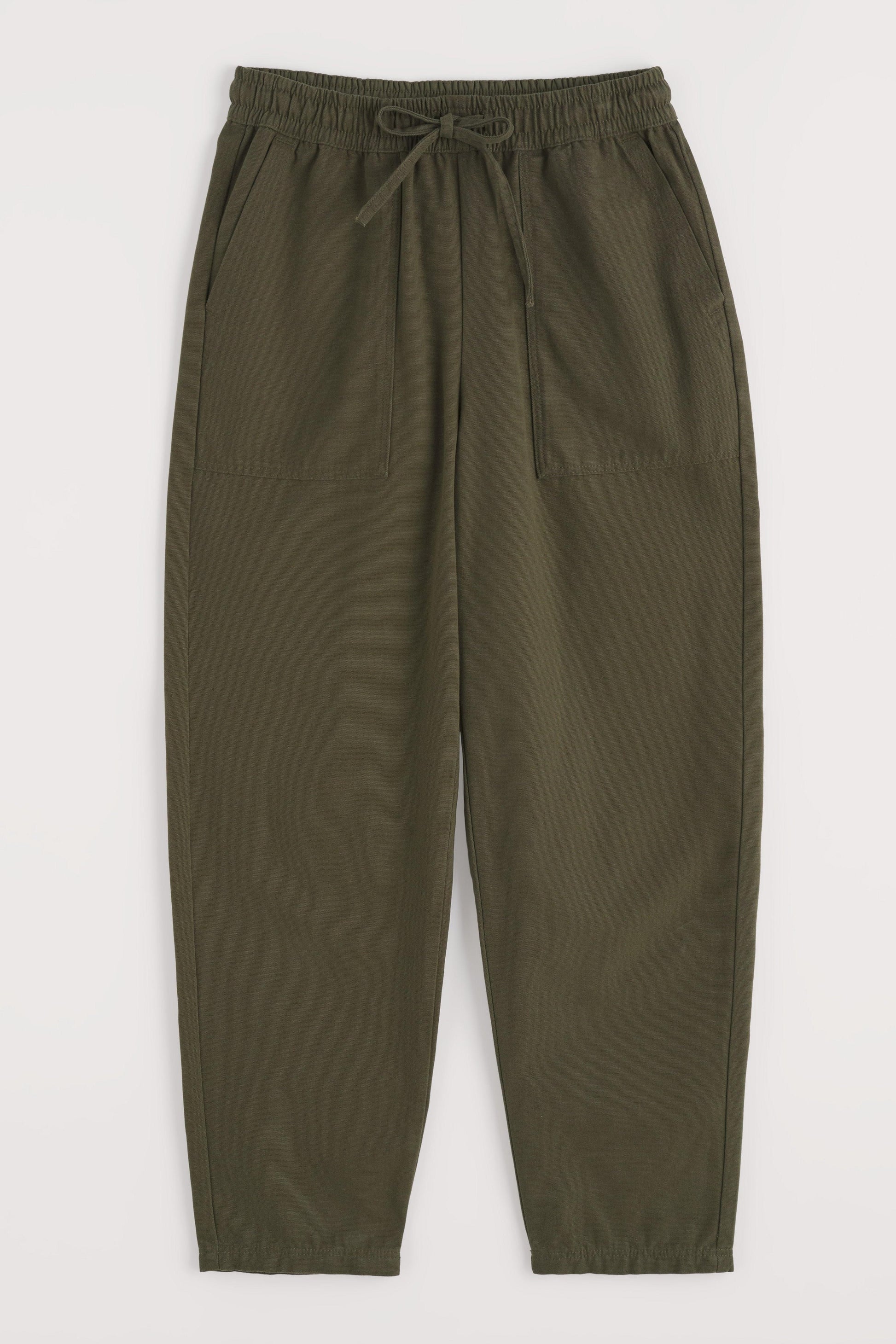 Green organic cotton pants with an elastic waistband on a white background
