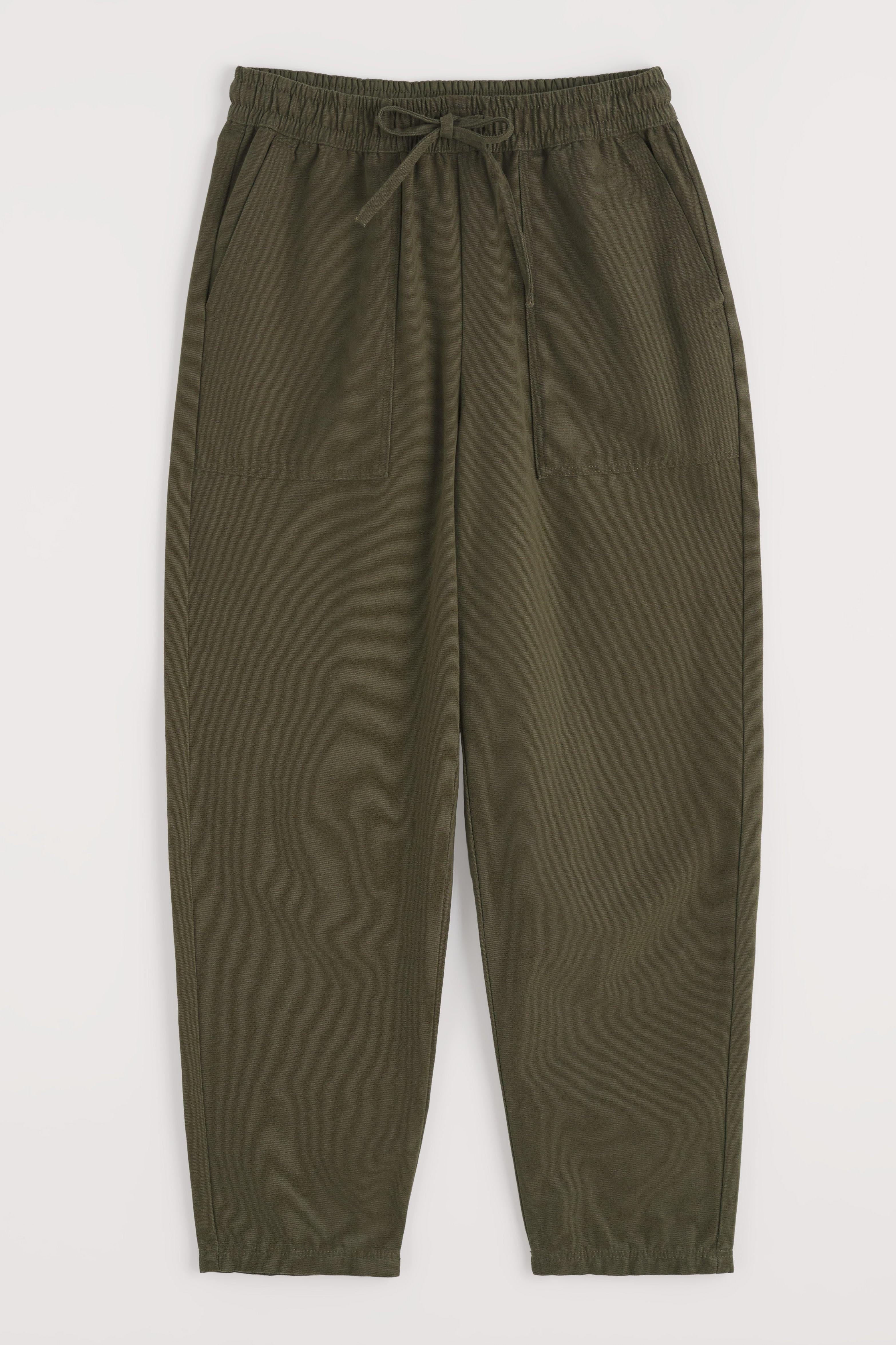 Green organic cotton pants with an elastic waistband on a white background