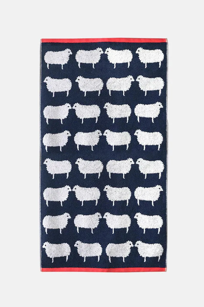 Navy towel with white sheep pattern on a white background