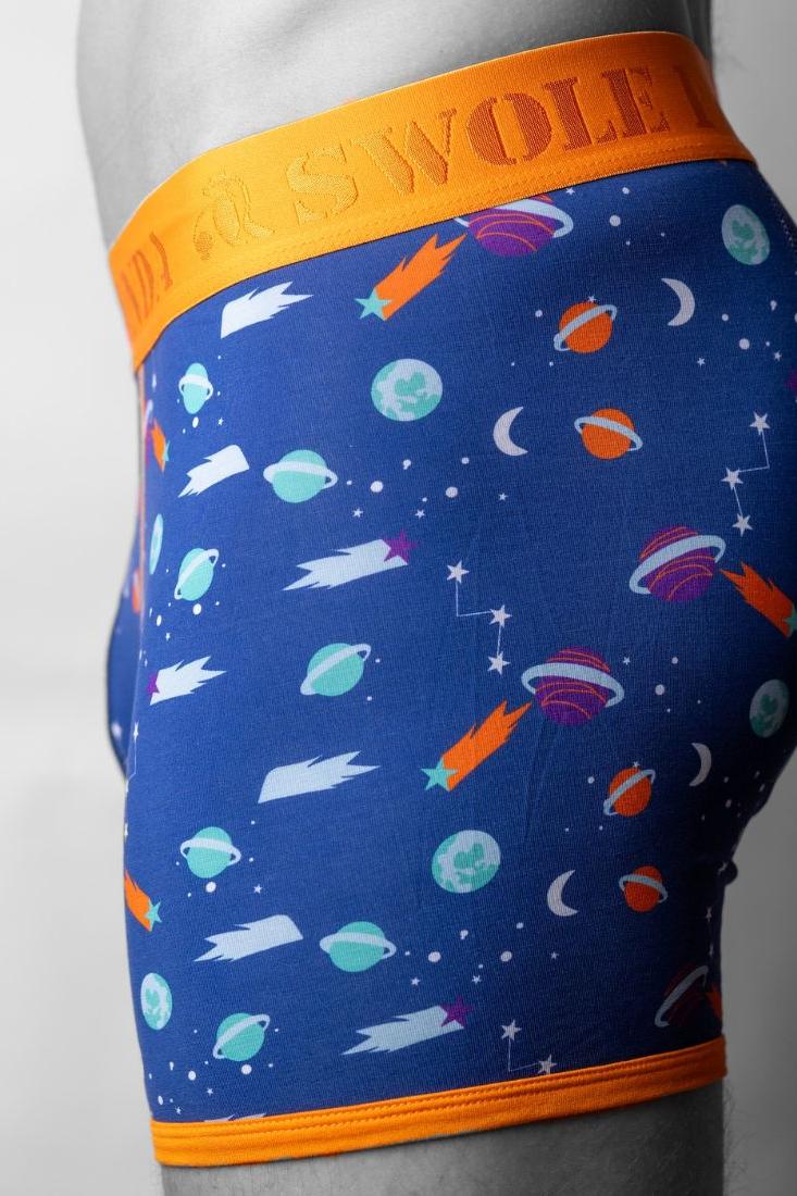 Side view of men wearing breathable space theme boxers with planets and comets pattern