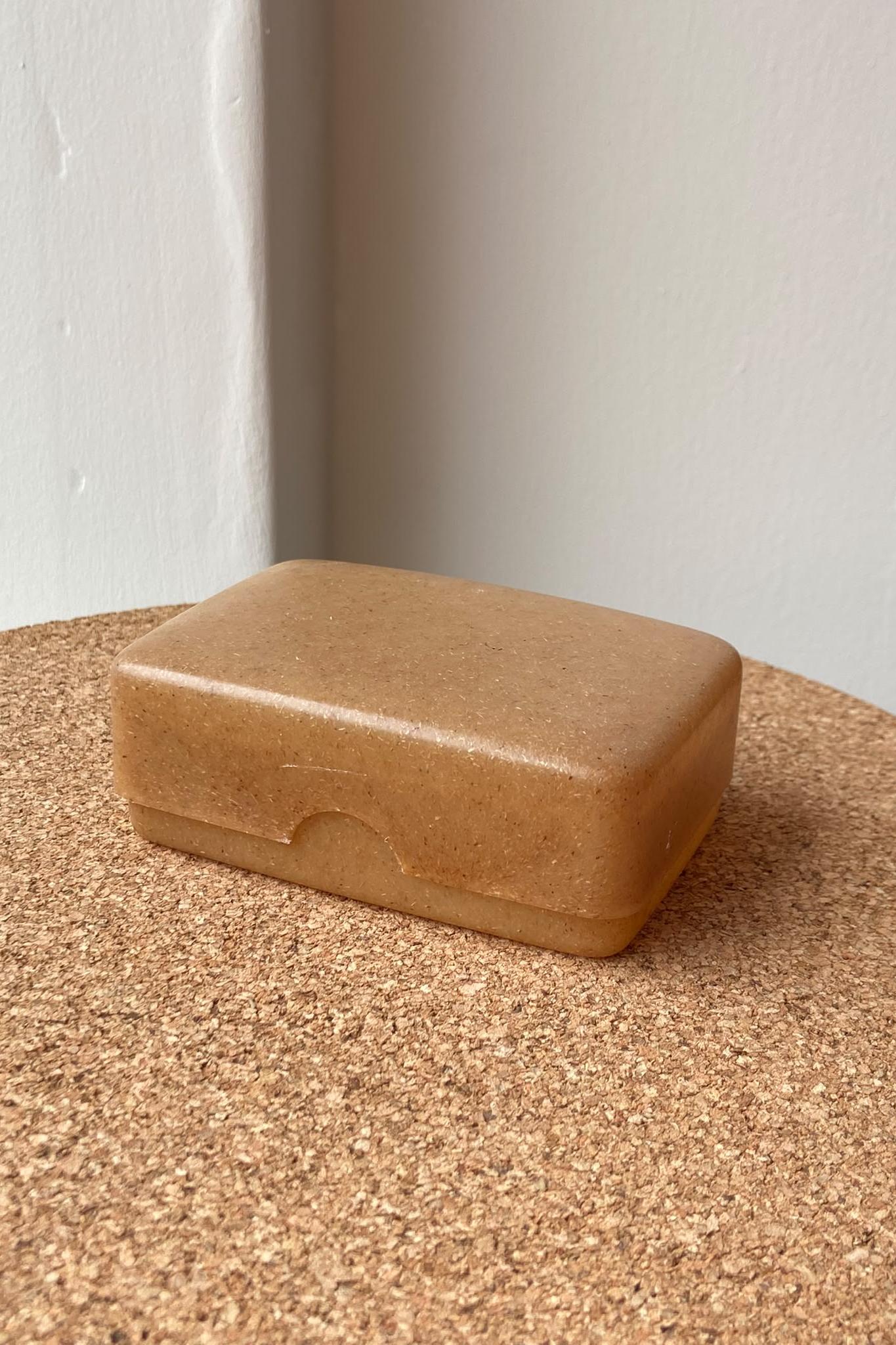 Brown soap box on cork surface