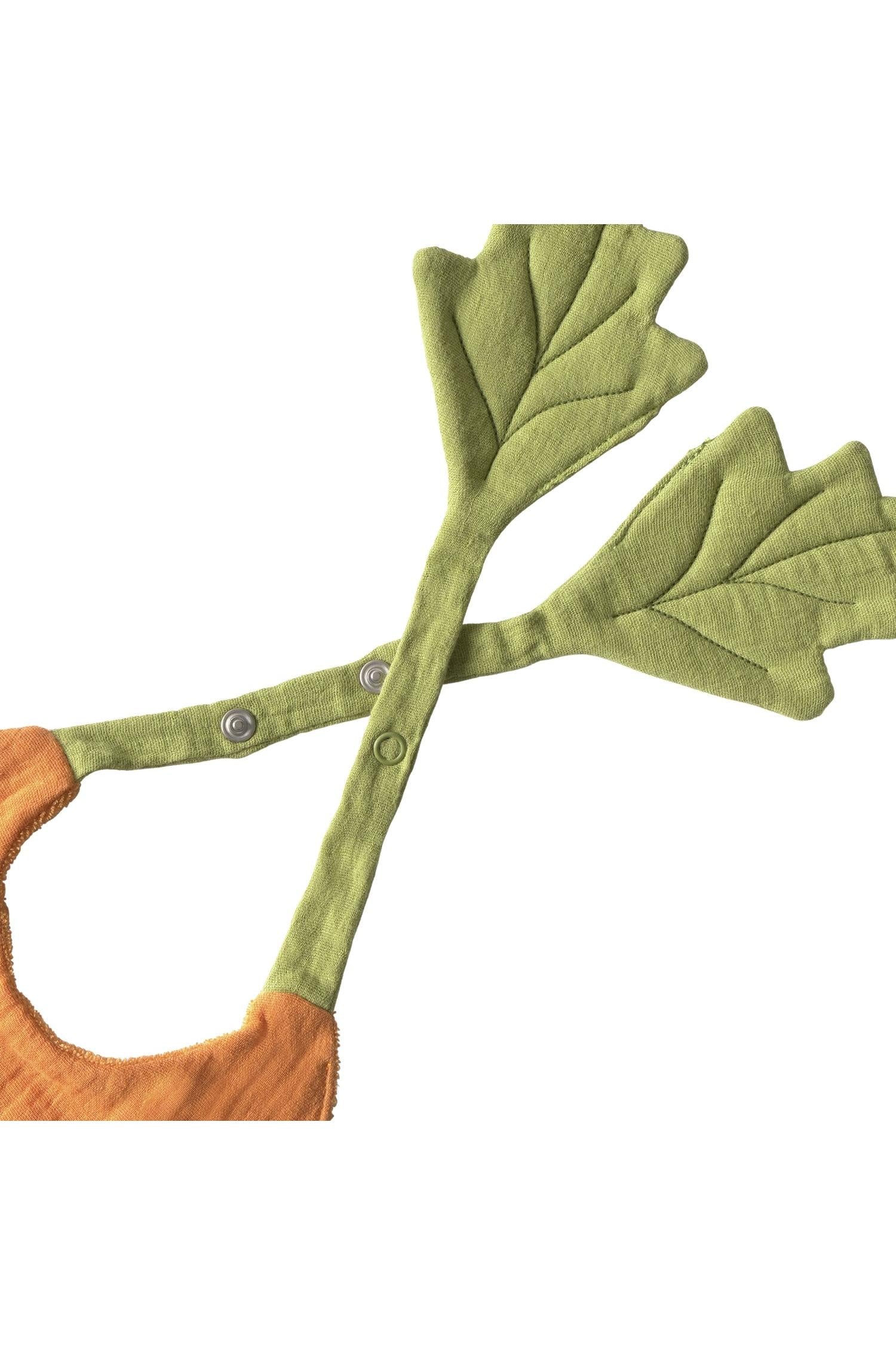 Green leaf-shaped bib with metal buttons on a white background.