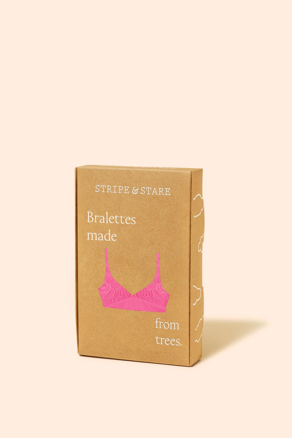 A kraft paper box for Stripe & Stare Bralettes made from trees, featuring a pink bralette illustration on the front, set against a solid pale peach background.