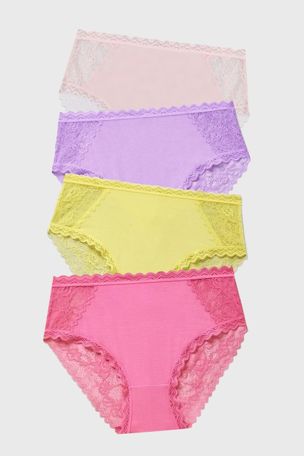 Set of four colourful lace-trimmed underwear on a light gray background