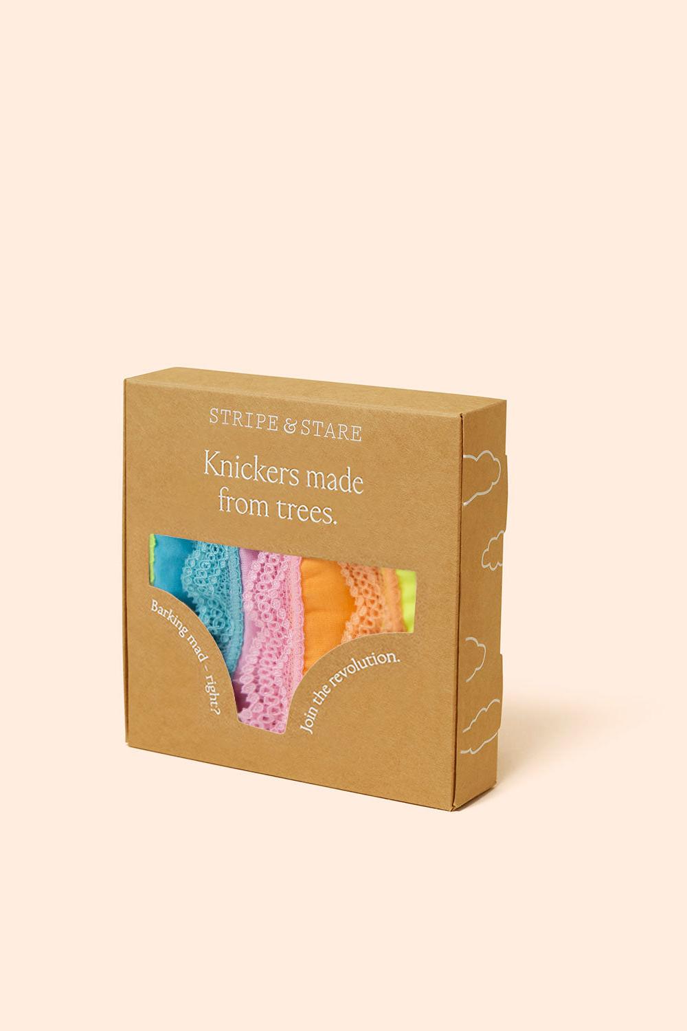 A kraft paper box for Stripe & Stare Knickers made from trees, featuring a window that displays four colourful knickers in blue, pink, orange, and yellow on a light beige background.