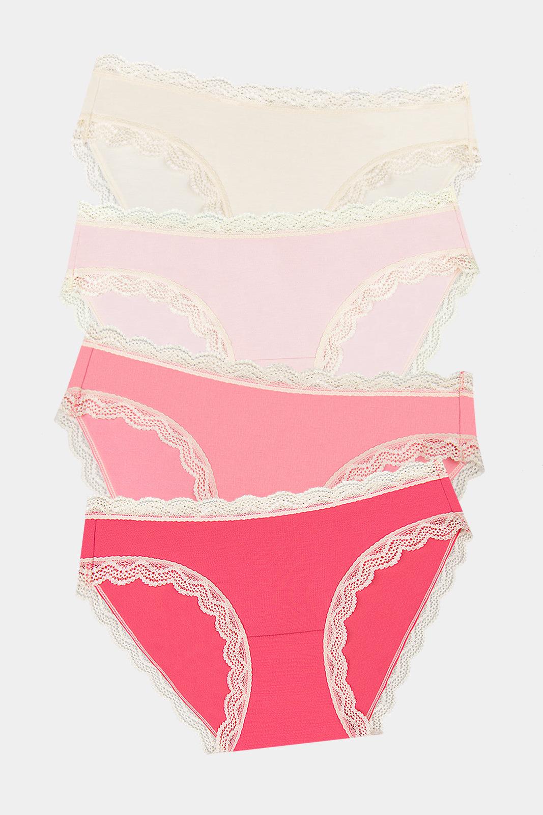 A stack of Stripe & Stare women's underwear in various shades of pink and cream with lace trim.