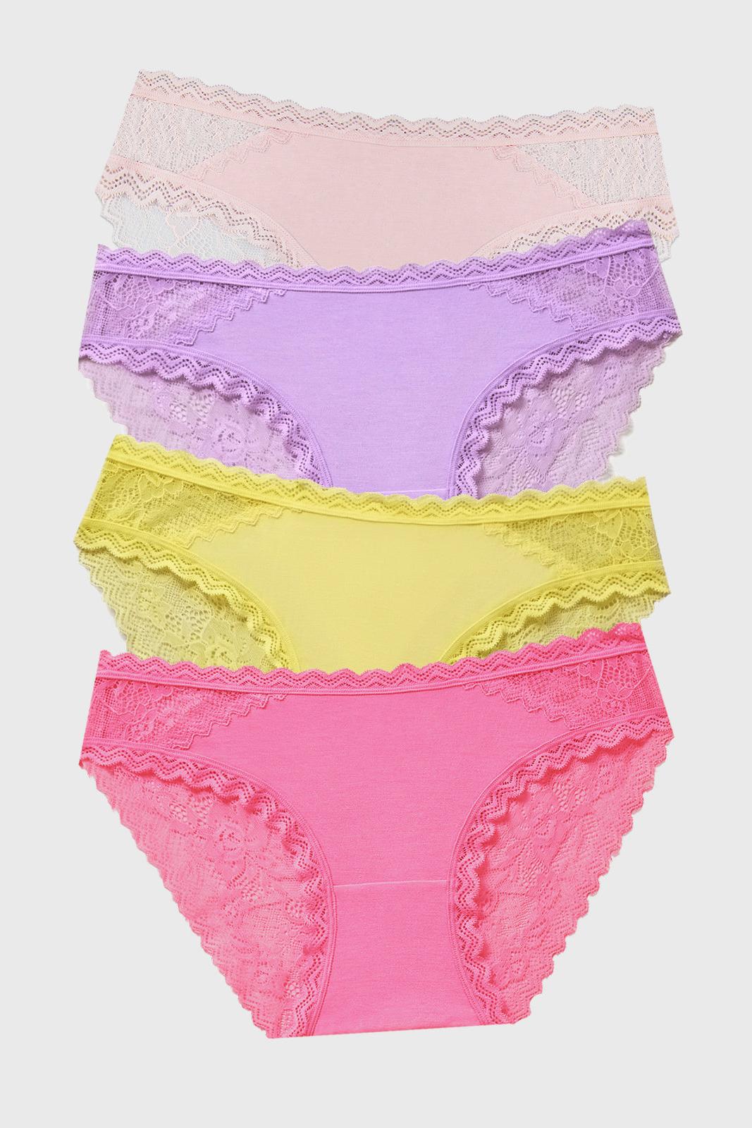 Set of four colourful lace-trimmed underwear on a light gray background