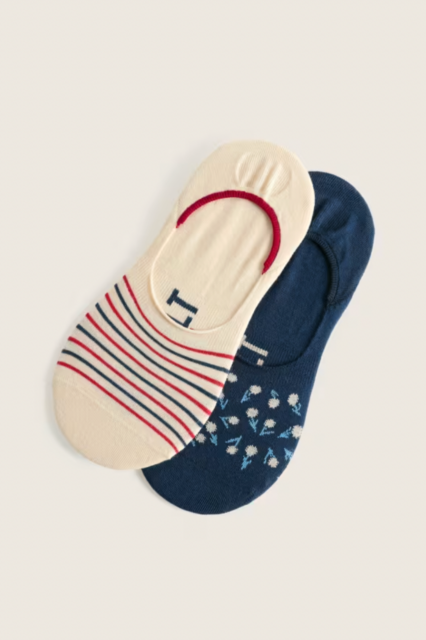 Two pairs of organic cotton no-show socks, one striped cream and one dark blue with floral pattern.