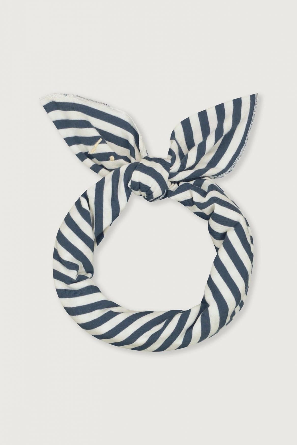 A navy blue and white striped fabric hair tie knotted into a loop, displayed against a solid light gray background.