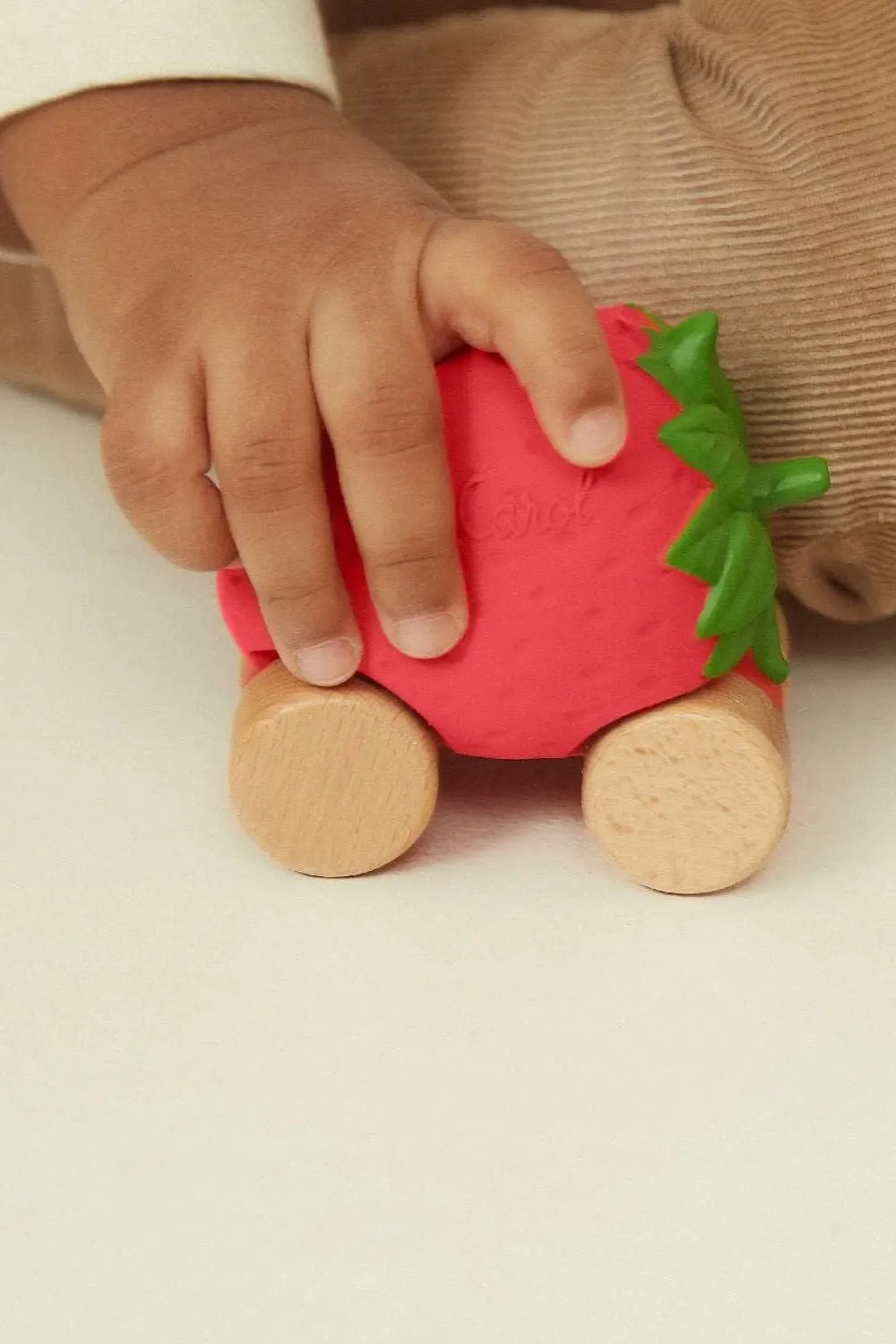 Sustainable infant car toy, hand-painted with natural pigments, biodegradable and non-toxic.