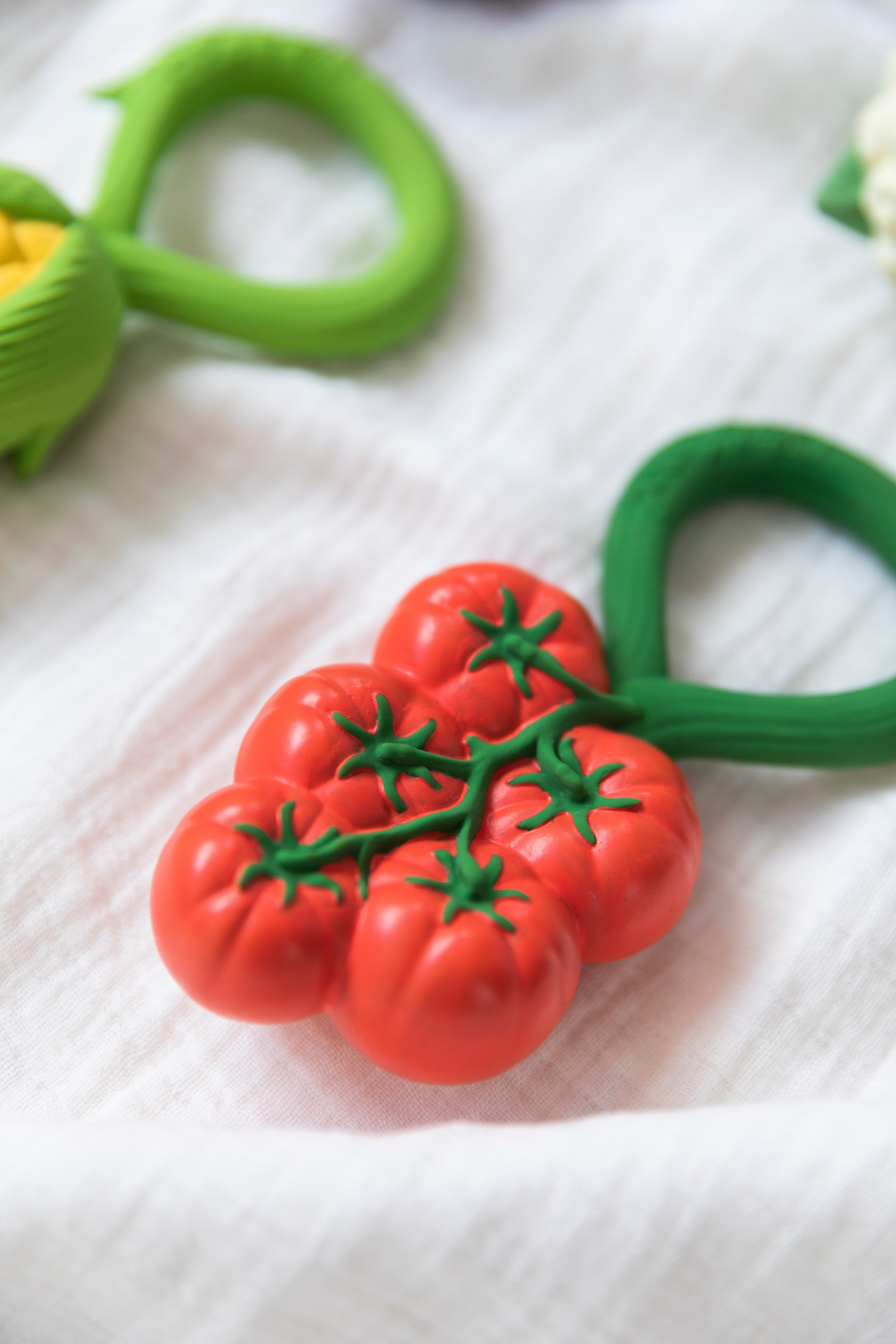 Handcrafted natural rubber tomato baby rattle and teether, non-toxic, mold-free, and designed for tiny hands.