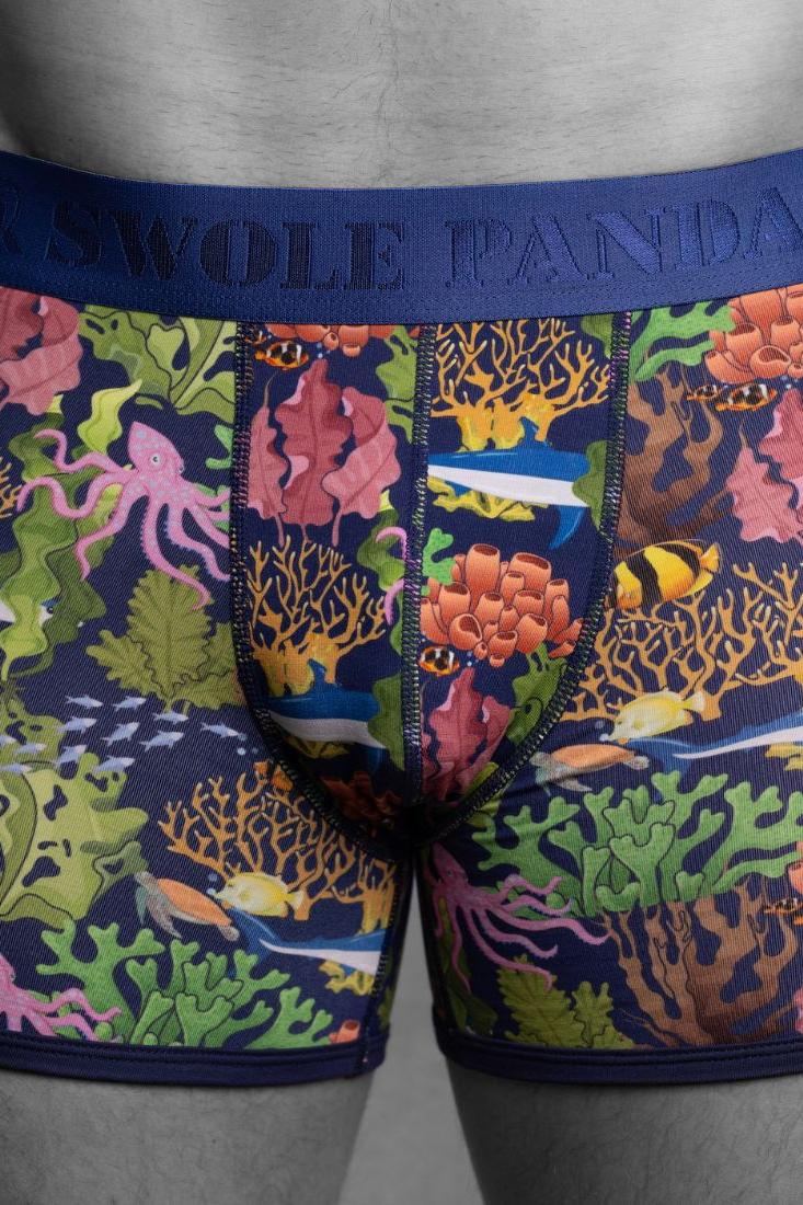 Close-up of Swole Panda boxer briefs featuring a colorful underwater coral reef print with sea life.