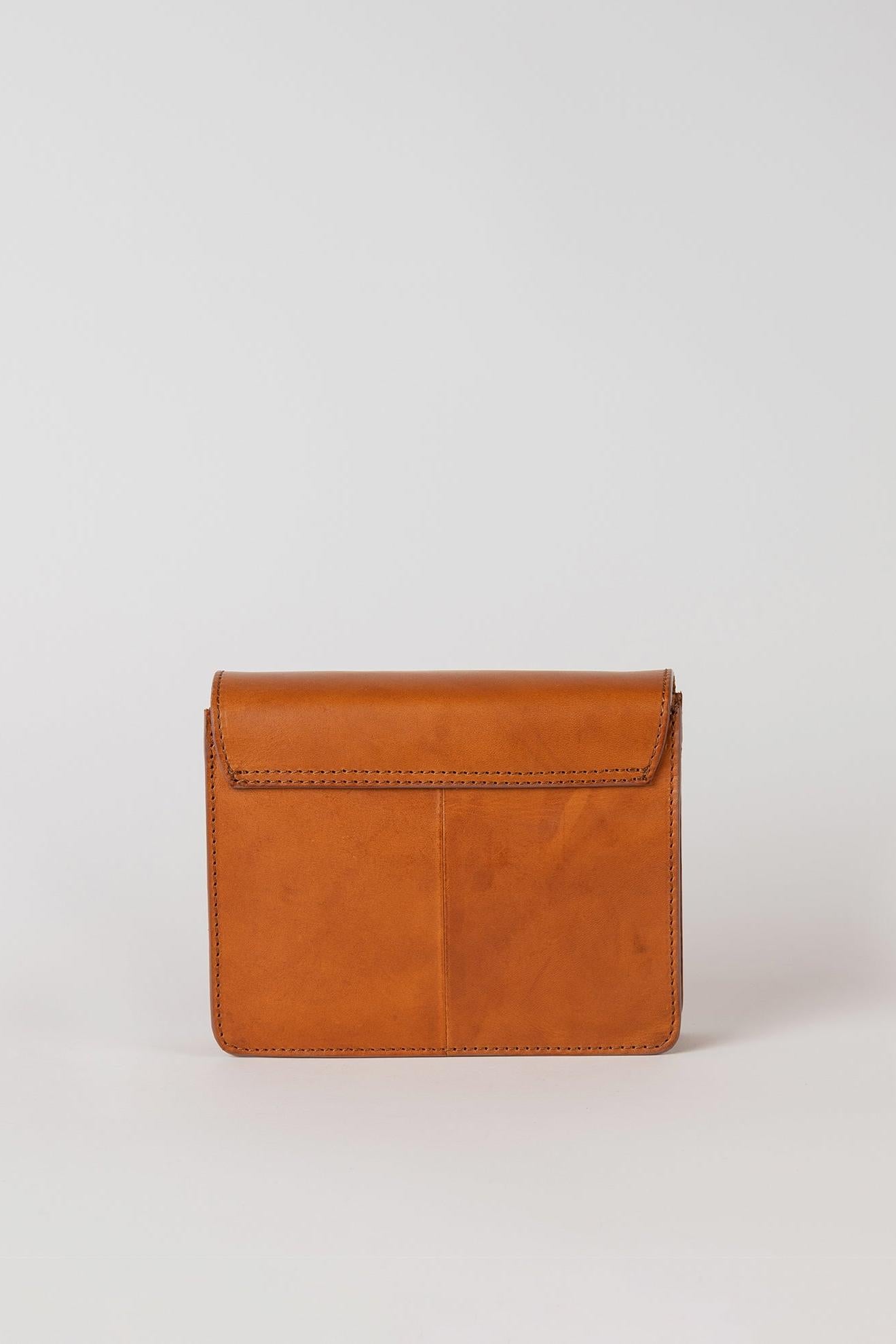 Brown leather handbag on a light gray background
