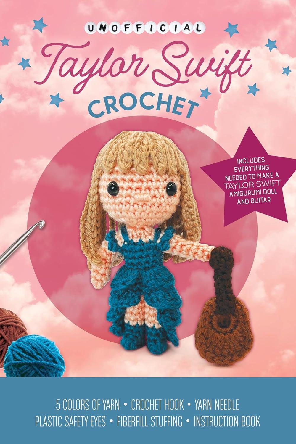 Crochet kit for creating a Taylor Swift-themed doll with yarn, hook, and guitar included on a pink background.