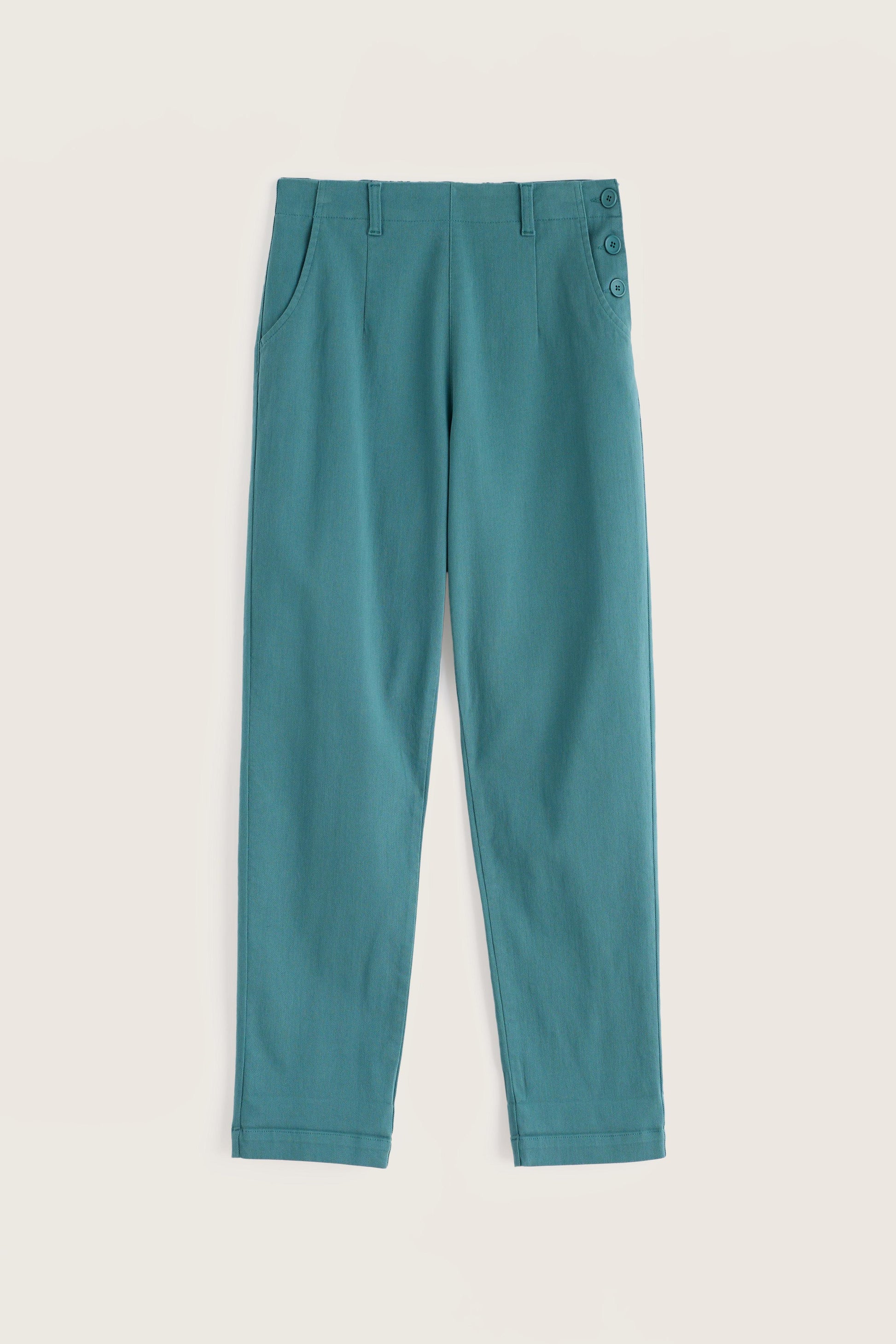 Teal pants on a beige background