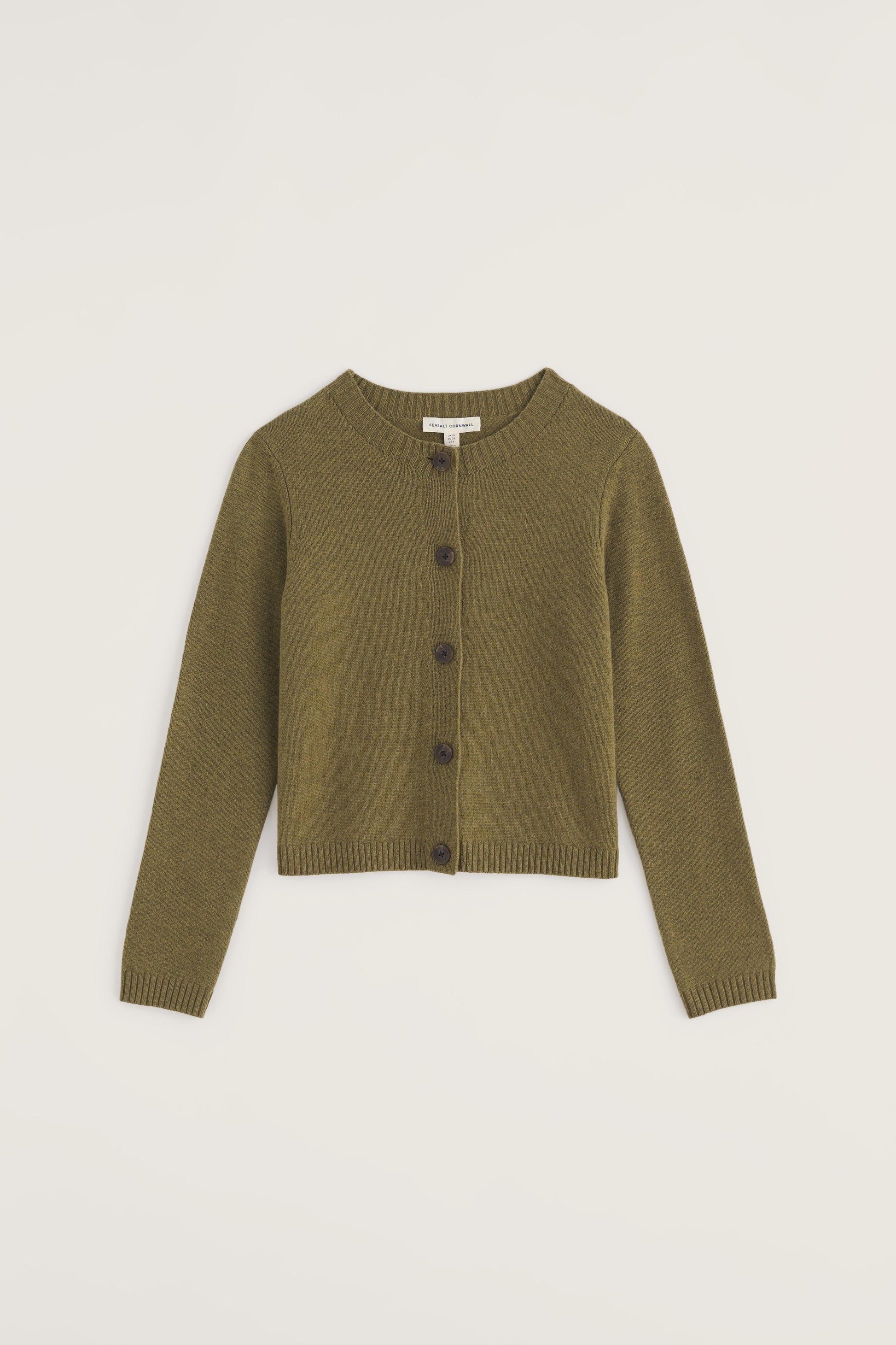 Green cardigan on a light beige background