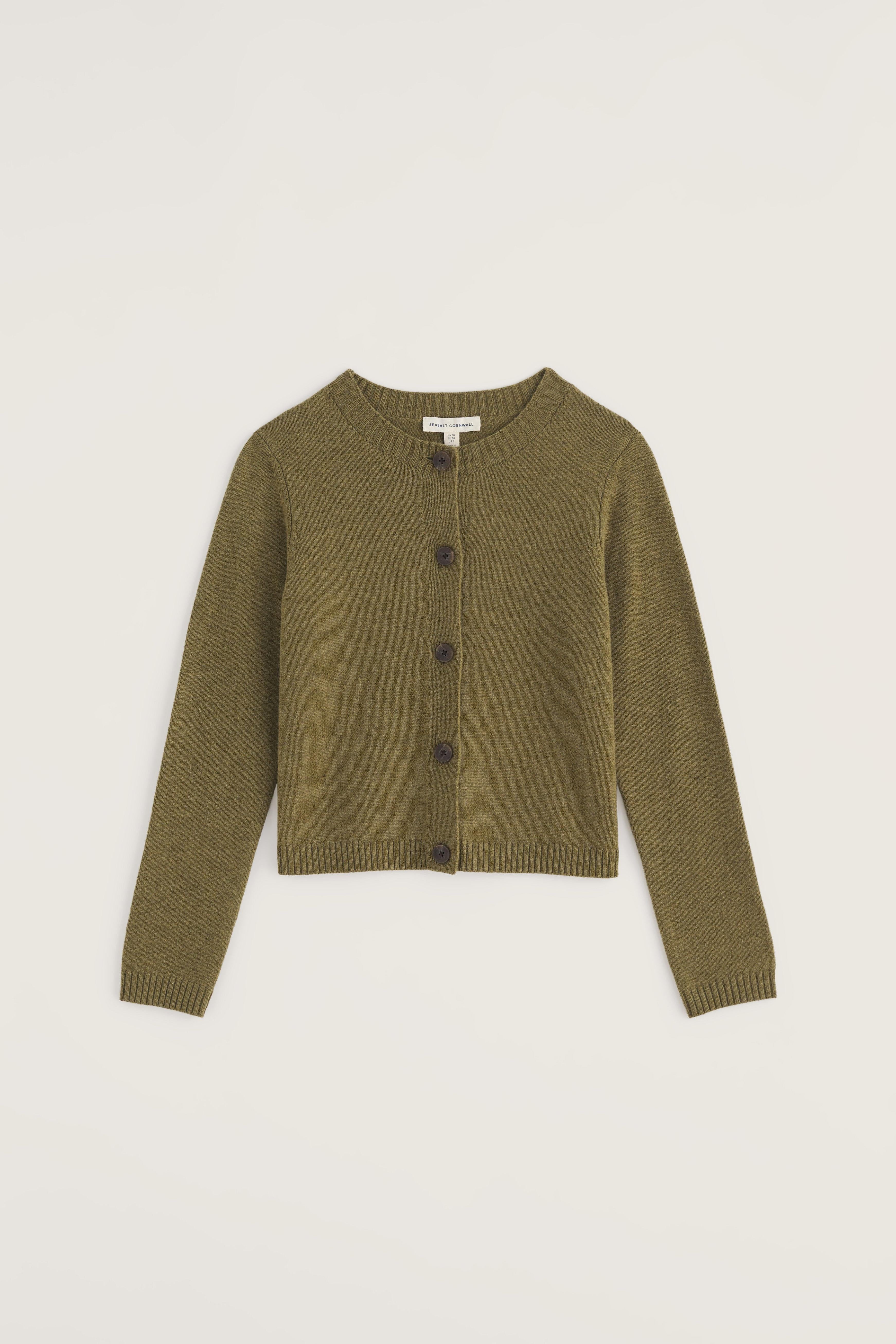 Green cardigan on a light beige background