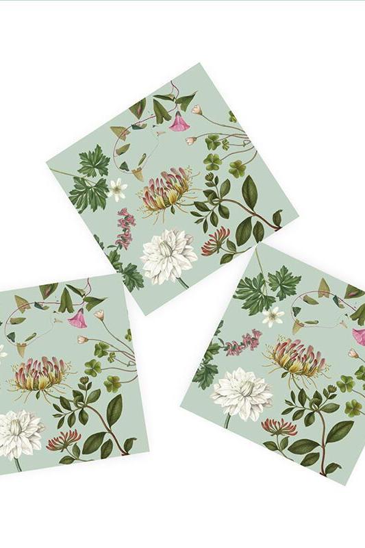 Three floral napkins on a light green background