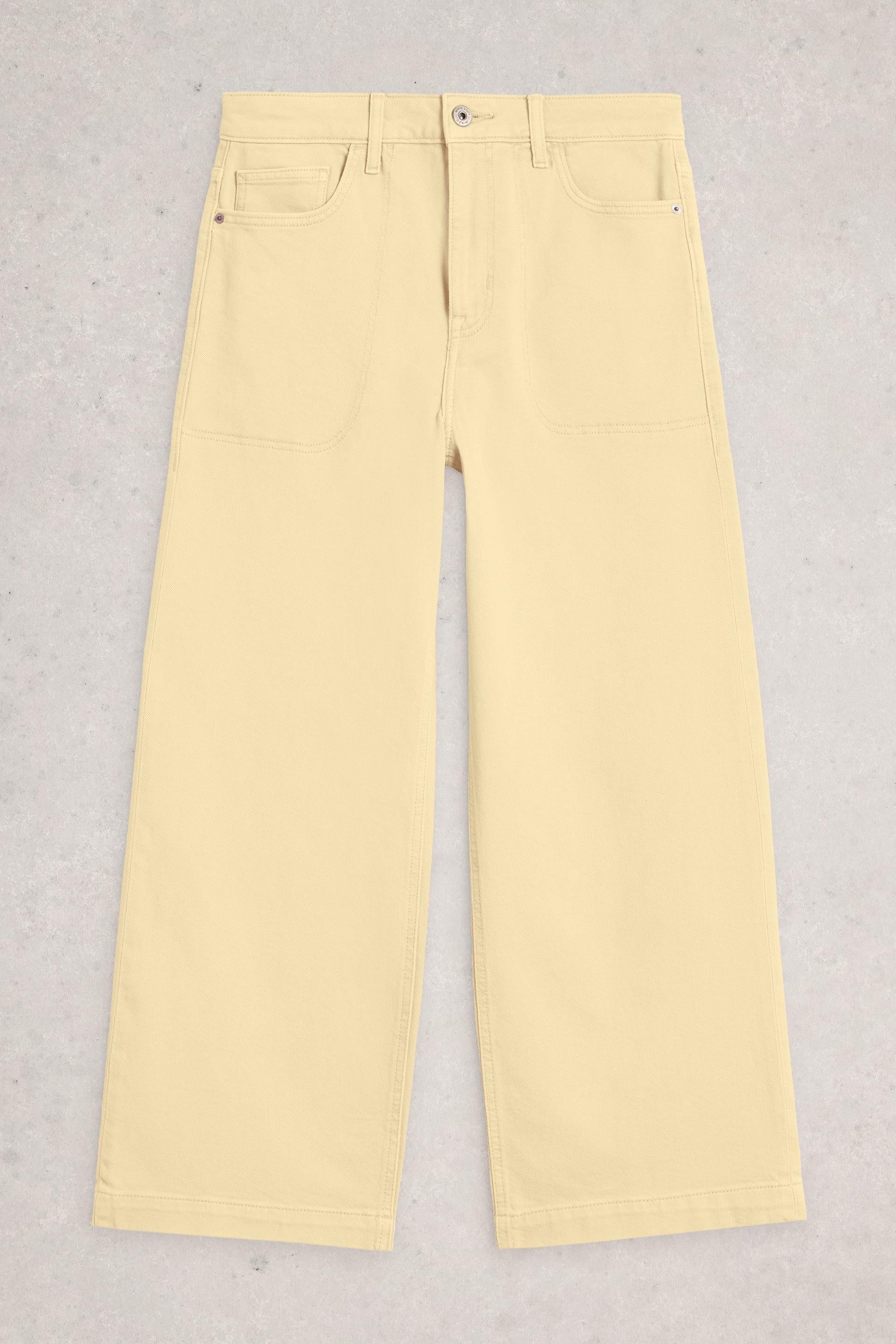 Light yellow organic cotton tia jeans on a light gray background