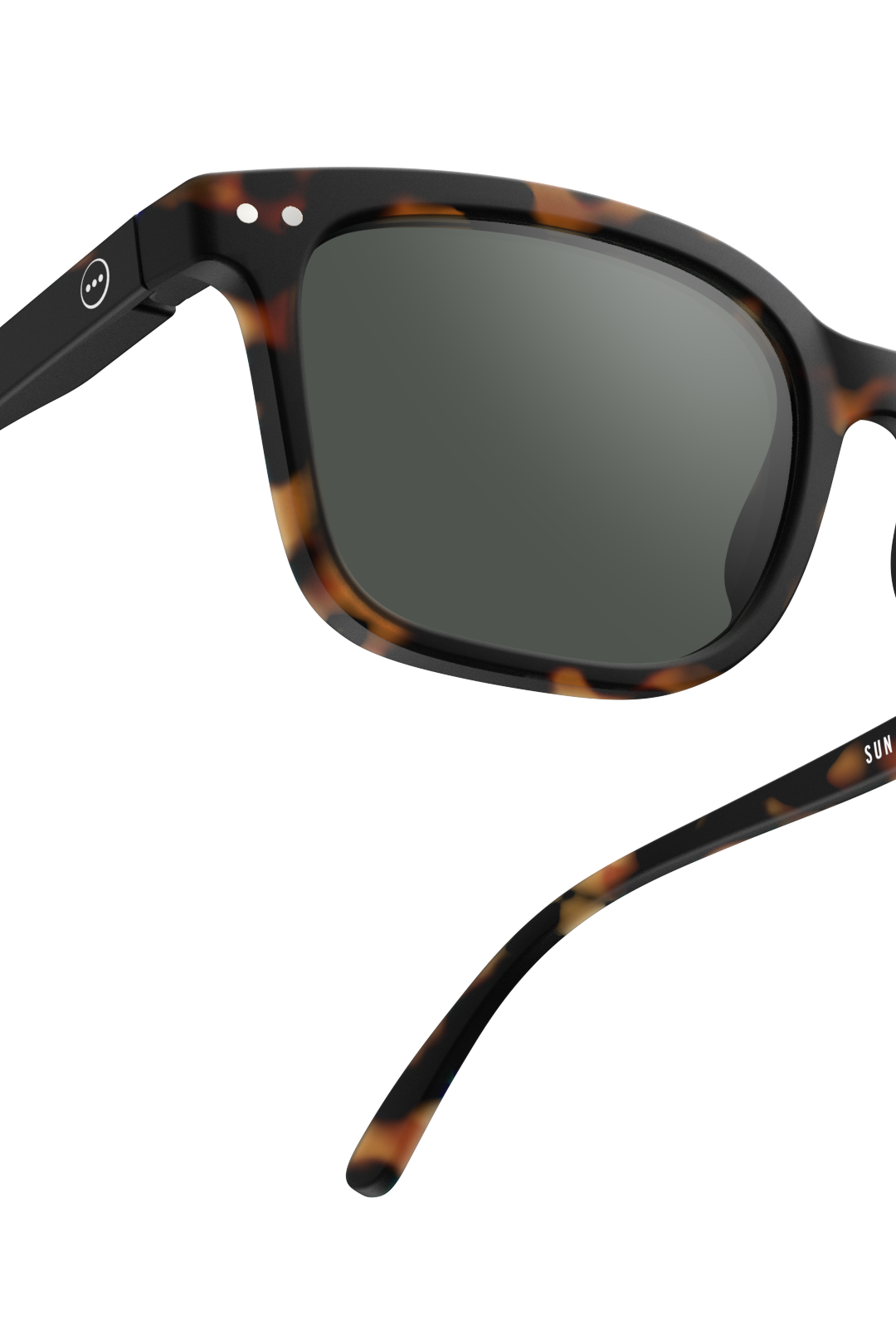 Close-up of tortoise shell Izipizi sunglasses with dark lenses against a plain white background.