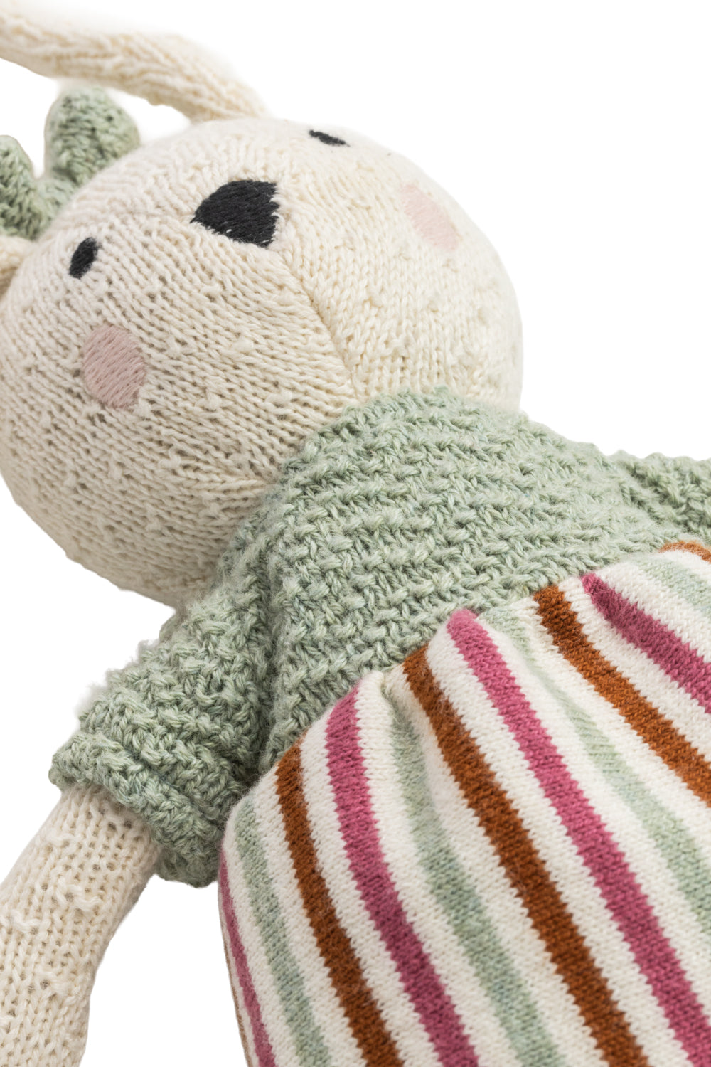 Knitted toy with a striped skirt on a white background
