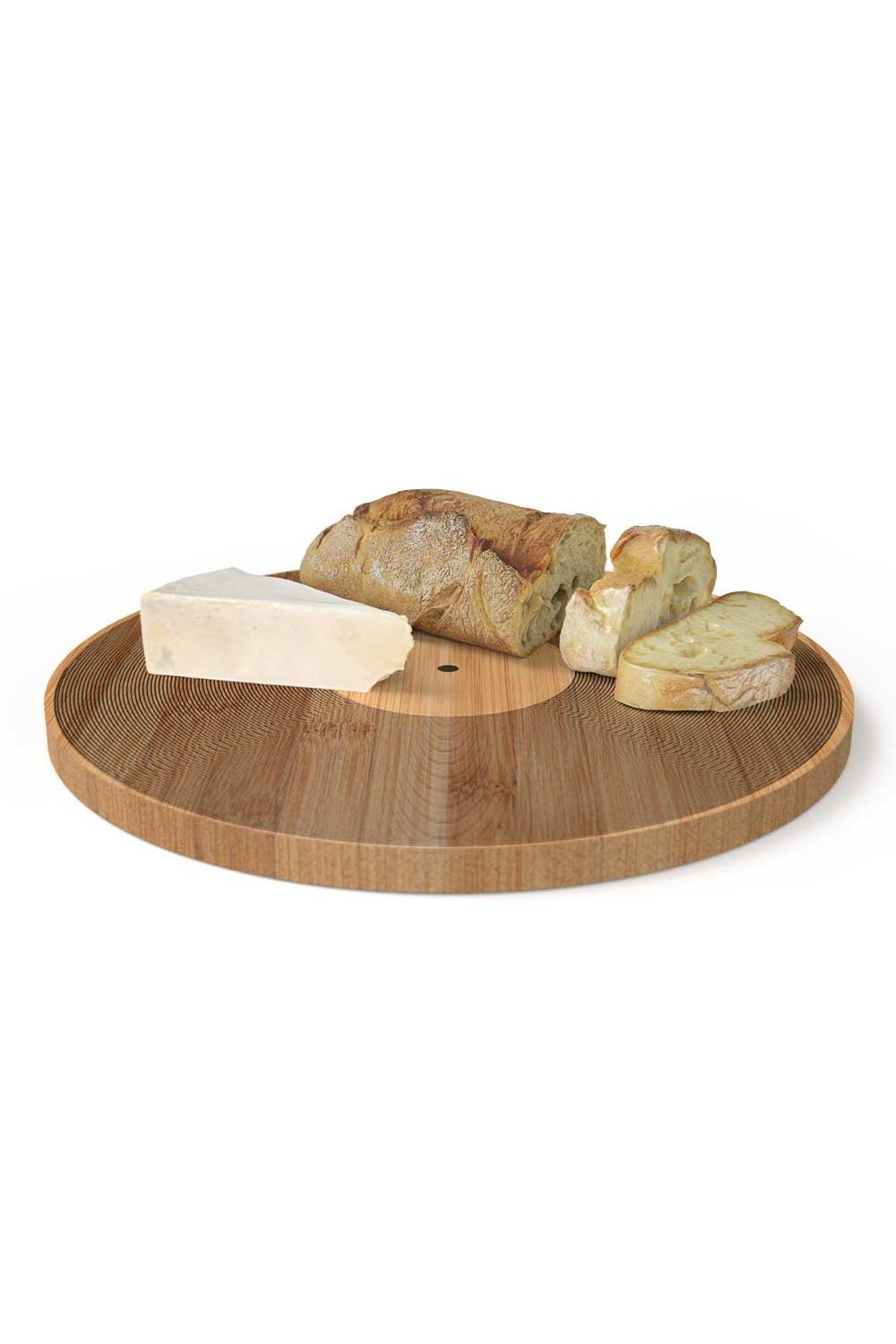Round wooden serving board with a circular center cutout, styled with a loaf of bread, a slice, and a wedge of cheese on a white background.