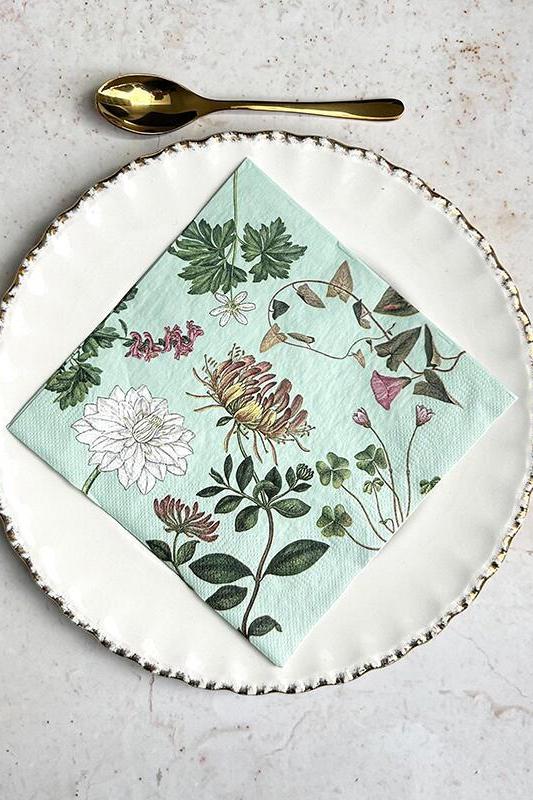 Napkin with floral design on a plate with cutlery