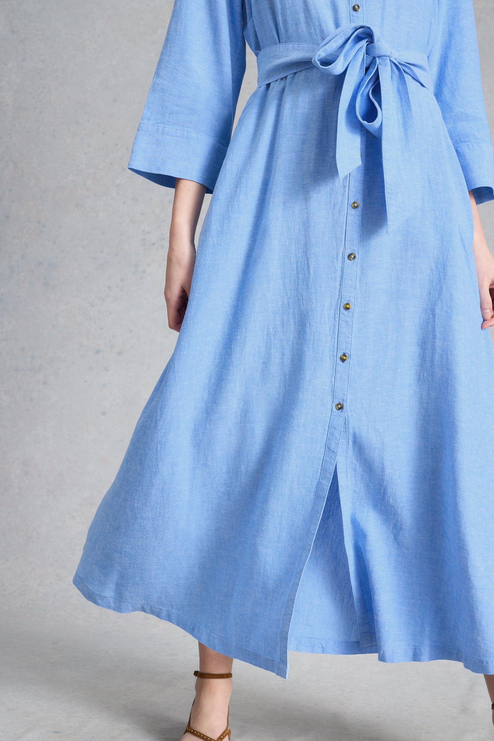 Close up of White Stuff light blue dress with a belt and buttons on a gray background