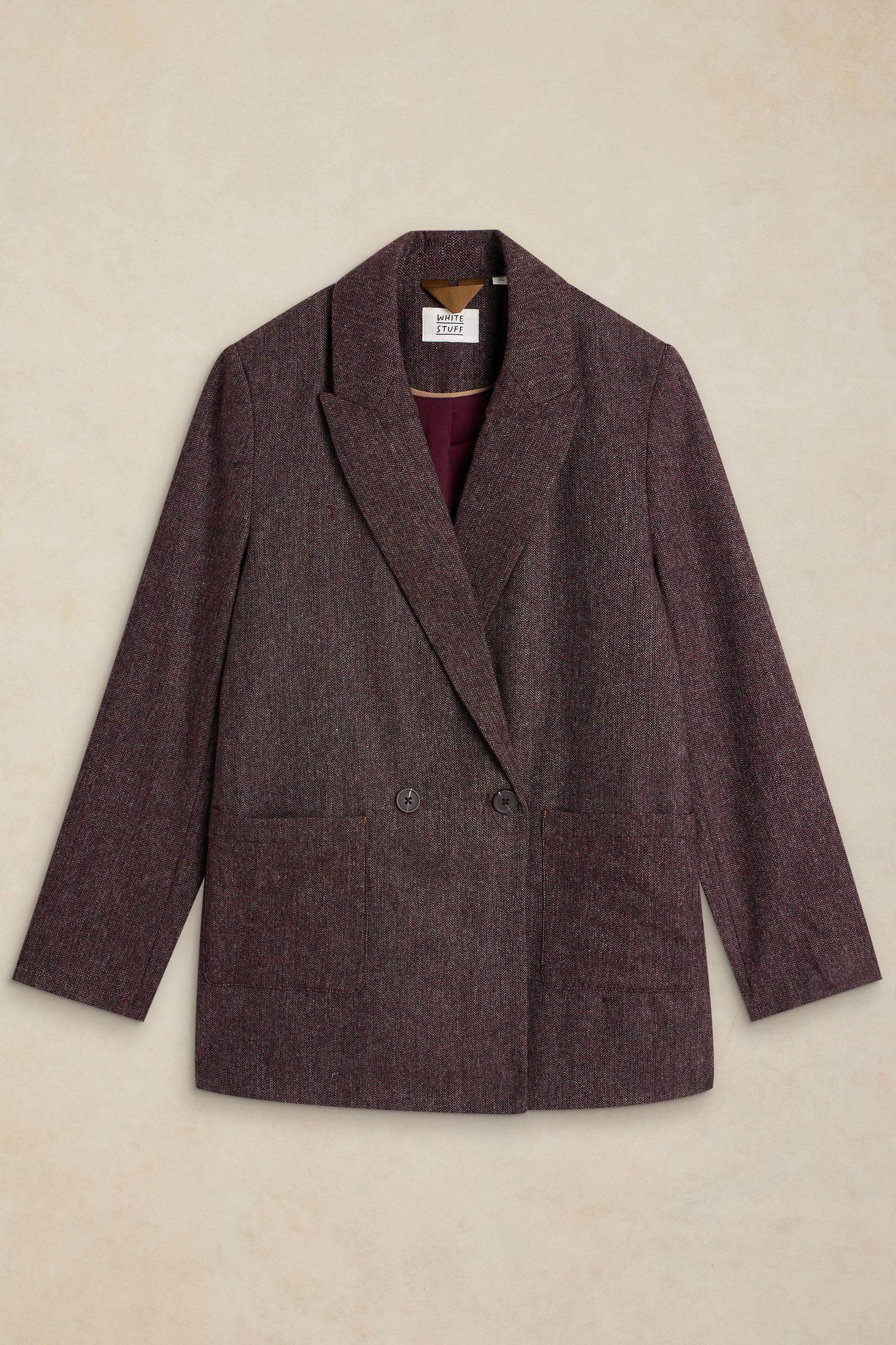 A dark brown textured wool blazer with a notched lapel and double-breasted buttons, laid flat against a light beige textured background.