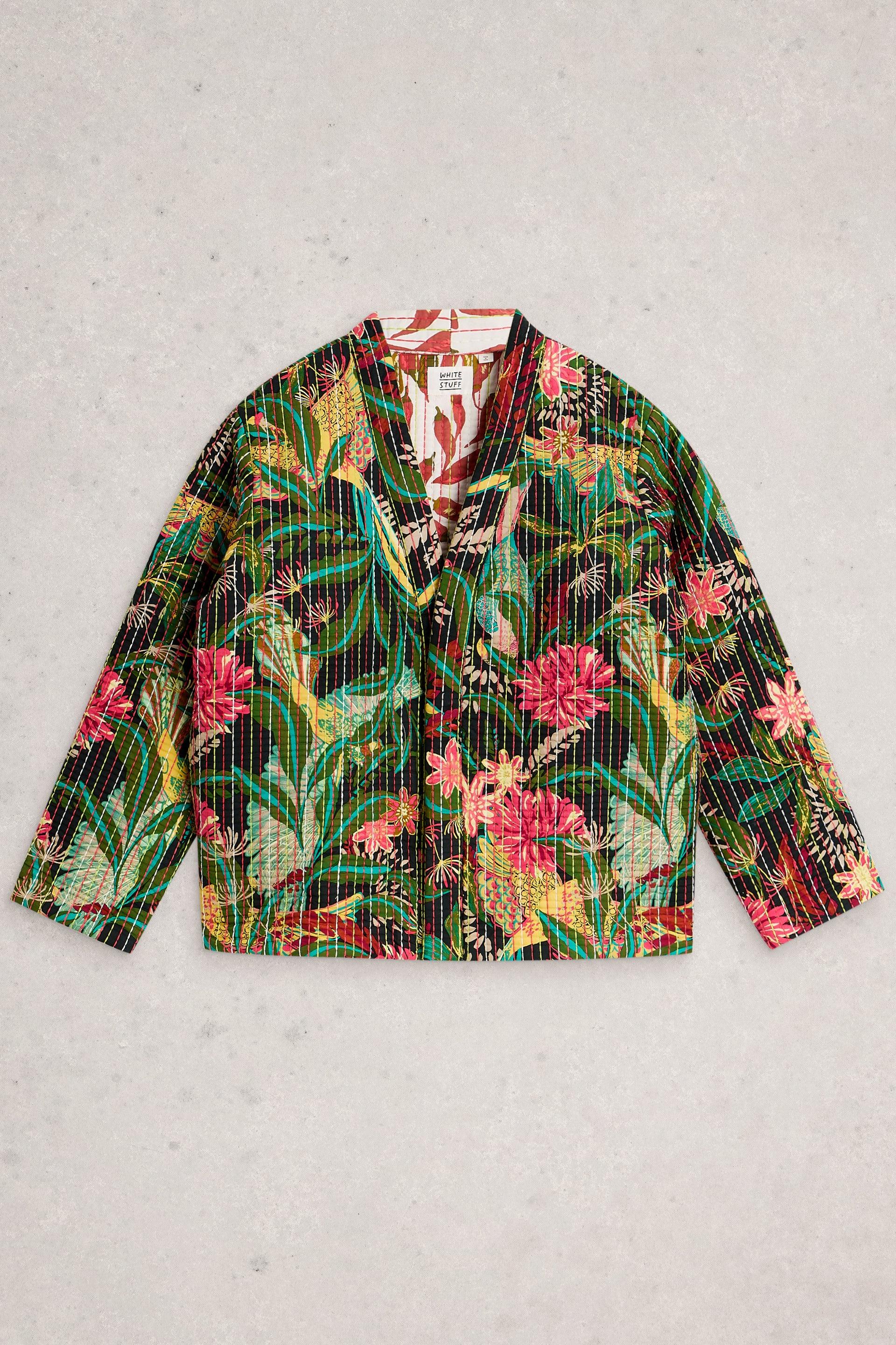 A quilted jacket with a vibrant tropical floral print made from organic cotton, displayed on a light textured background.