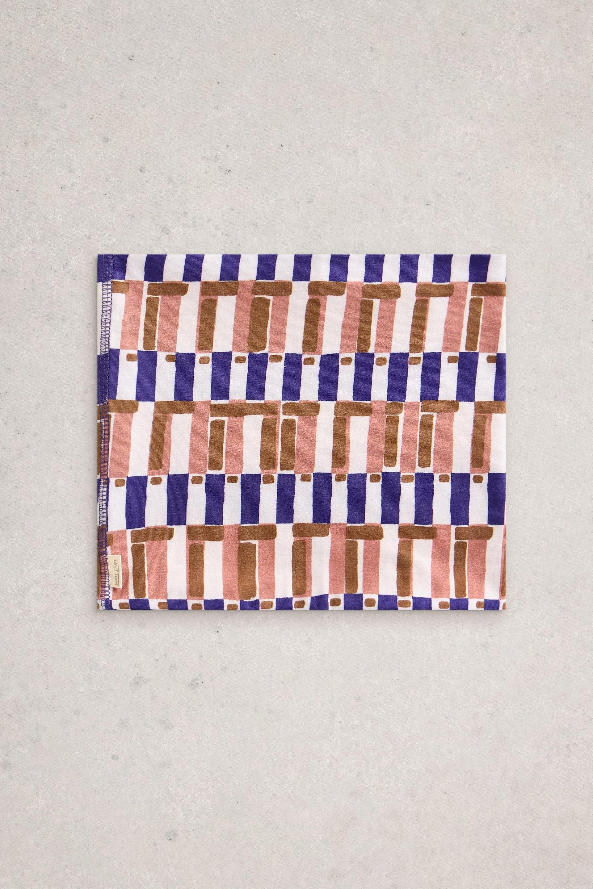 A White Stuff neck warmer featuring a geometric pattern in purple, pink, and brown on a neutral background