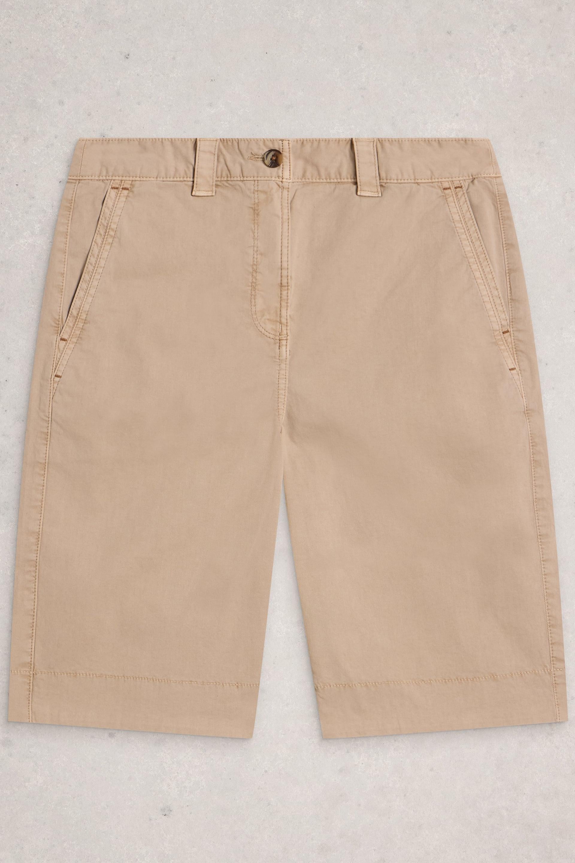 Beige organic cotton pants on a light gray background