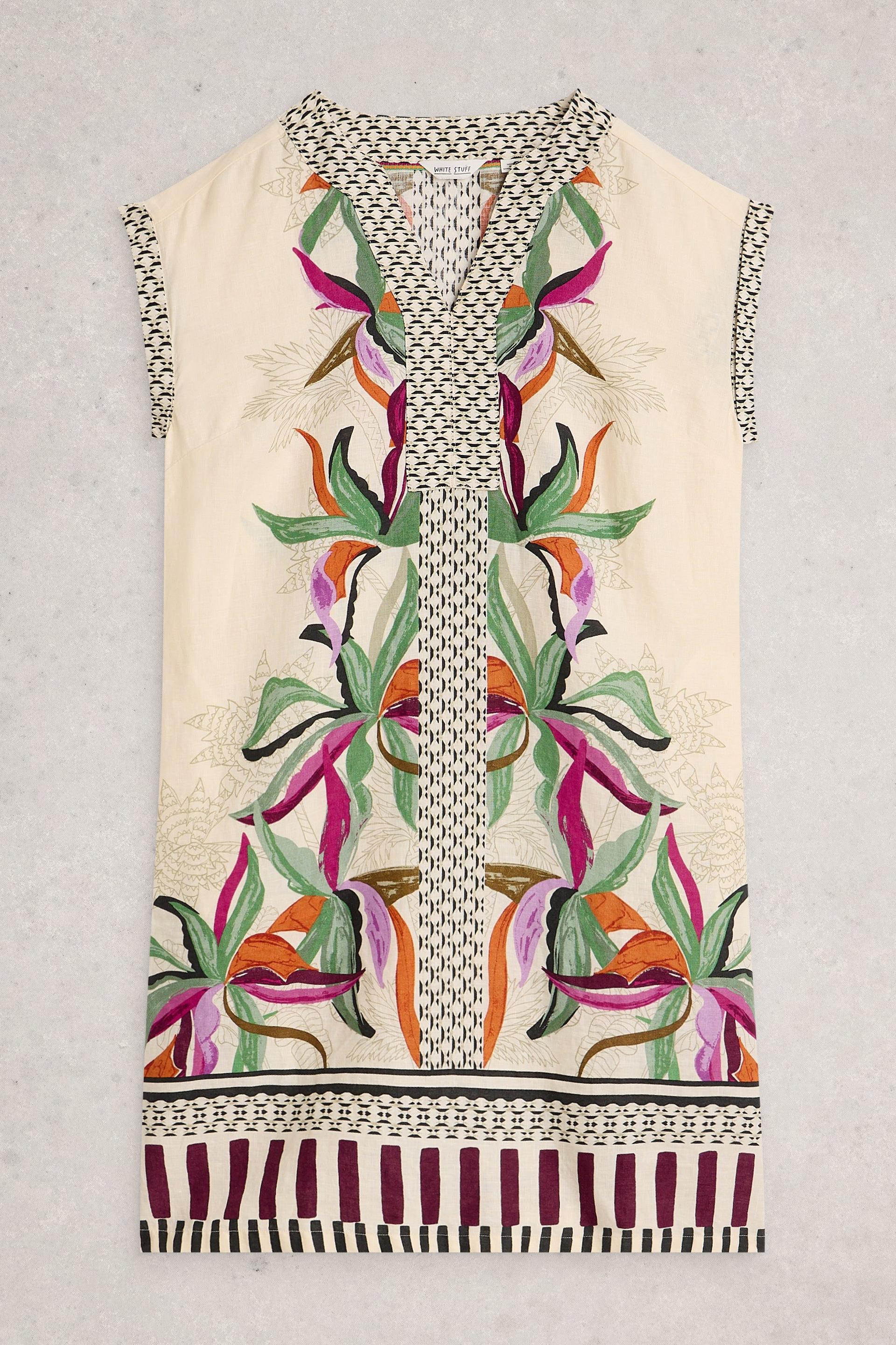 Decorative dress with floral pattern and chain details on a plain background