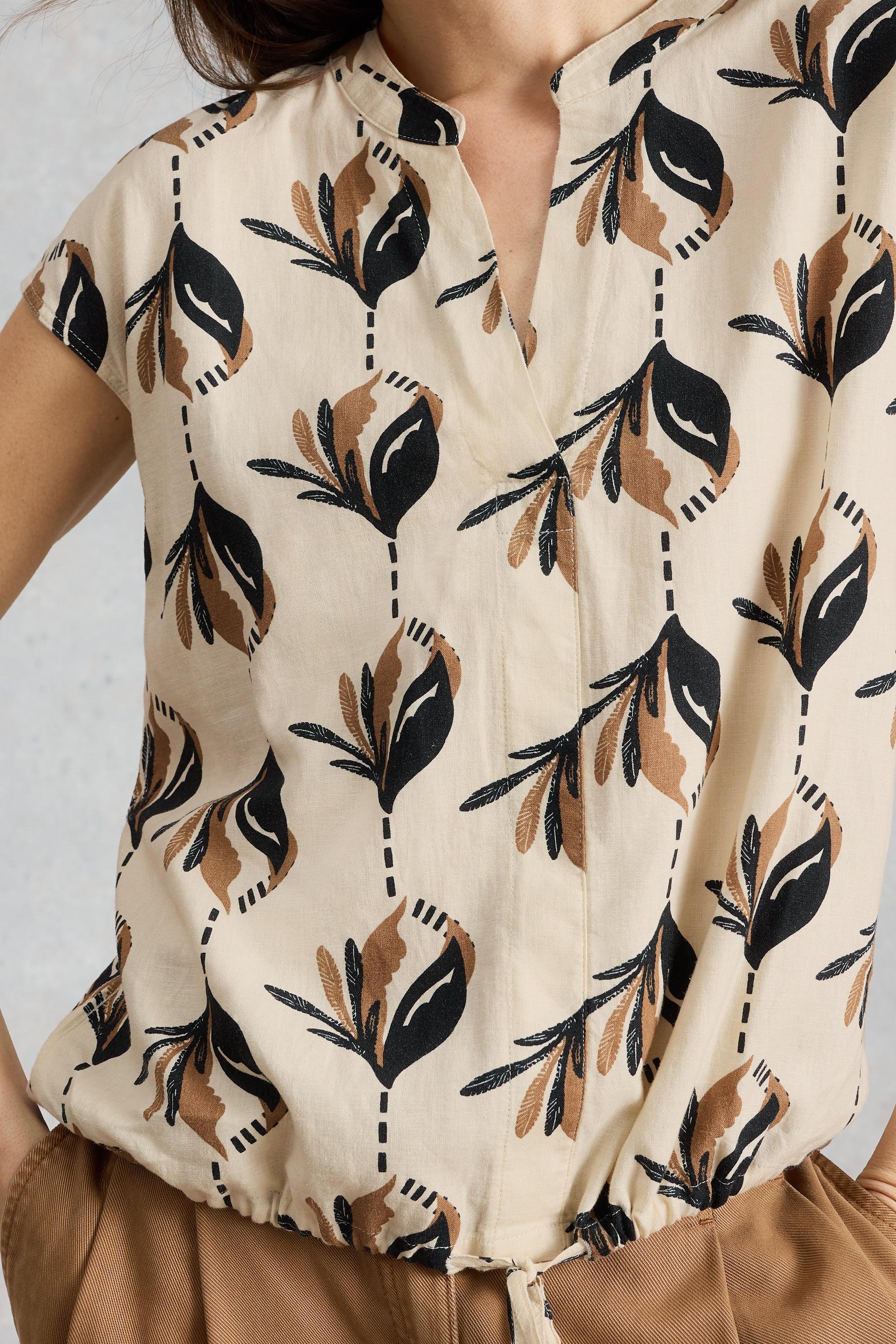 Beige White Stuff blouse with black and brown floral pattern worn by a person