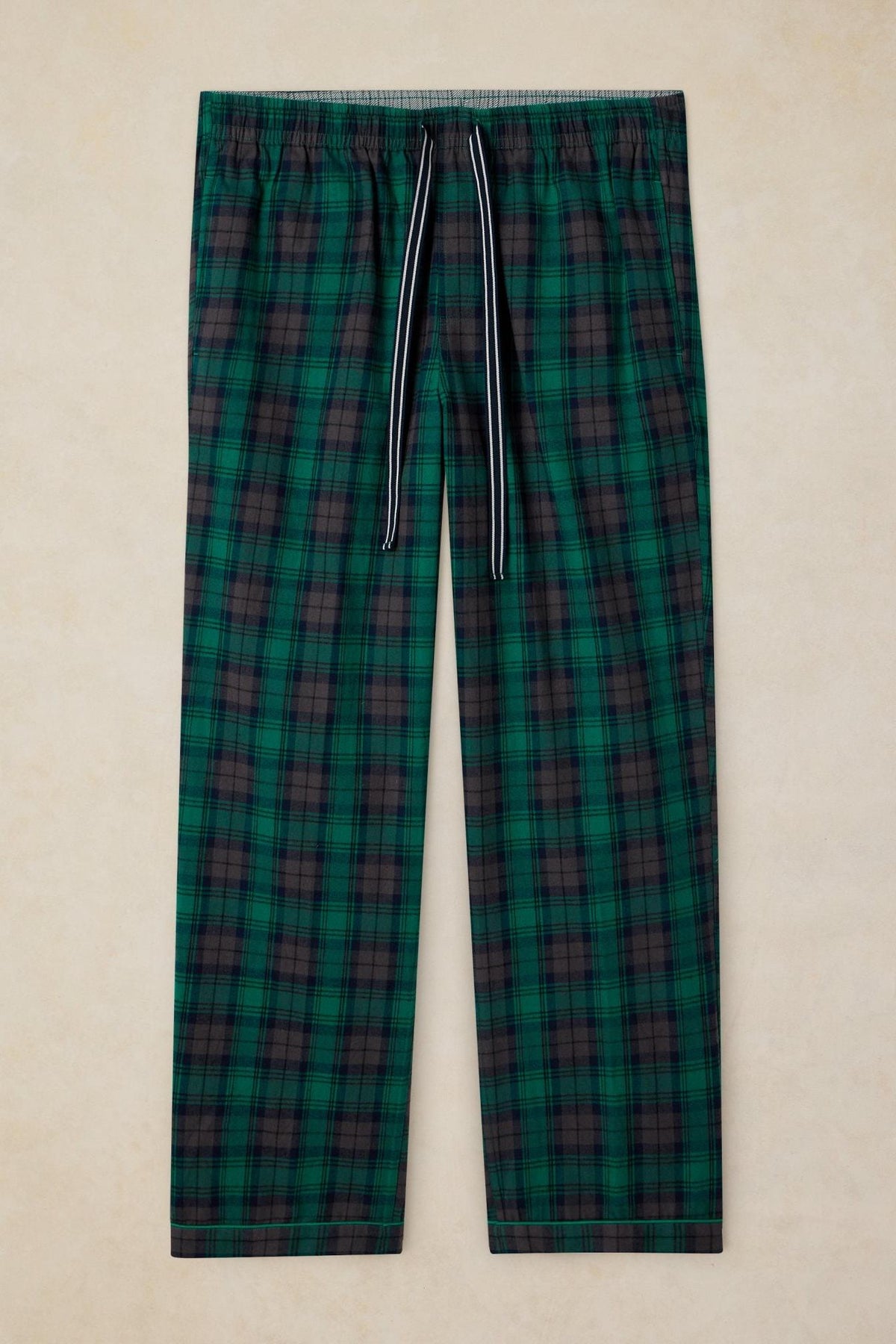White Stuff men's green plaid cotton pyjama trousers with a drawstring waist against a neutral background.