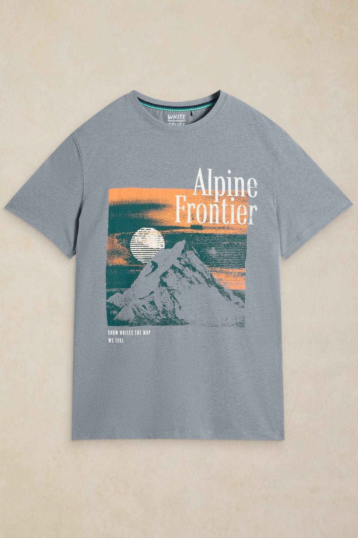White Stuff men's grey tshirt featuring an Alpine Frontier mountain graphic print on organic cotton fabric.