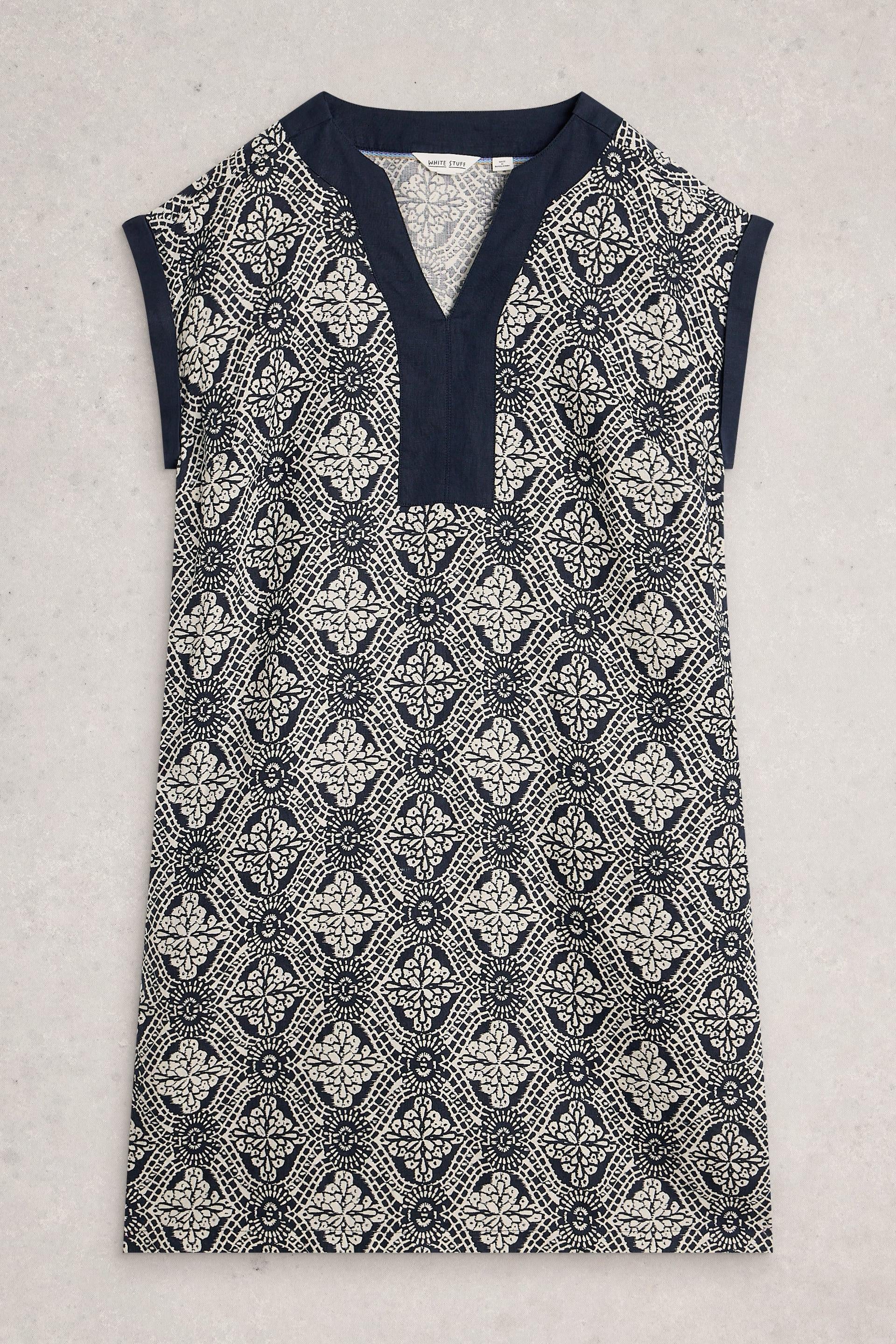Sleeveless White Stuff dress with navy and white pattern on a light gray background